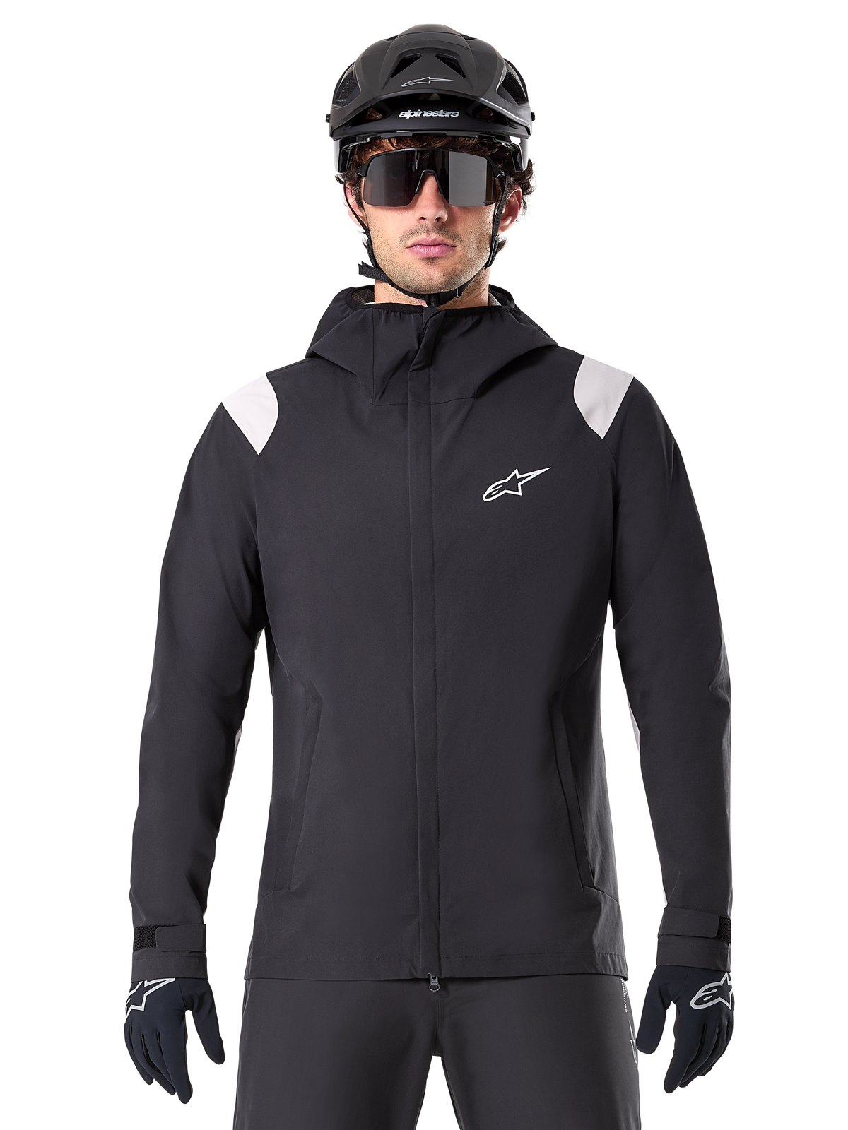 Alpinestars A-Dura Rain Jacket, MTB Rain Jacket, Black with white shoulder panels, worn with black MTB helmet, sunglasses, and gloves, waterproof design with hood and front zipper, sporty outdoor gear for cycling