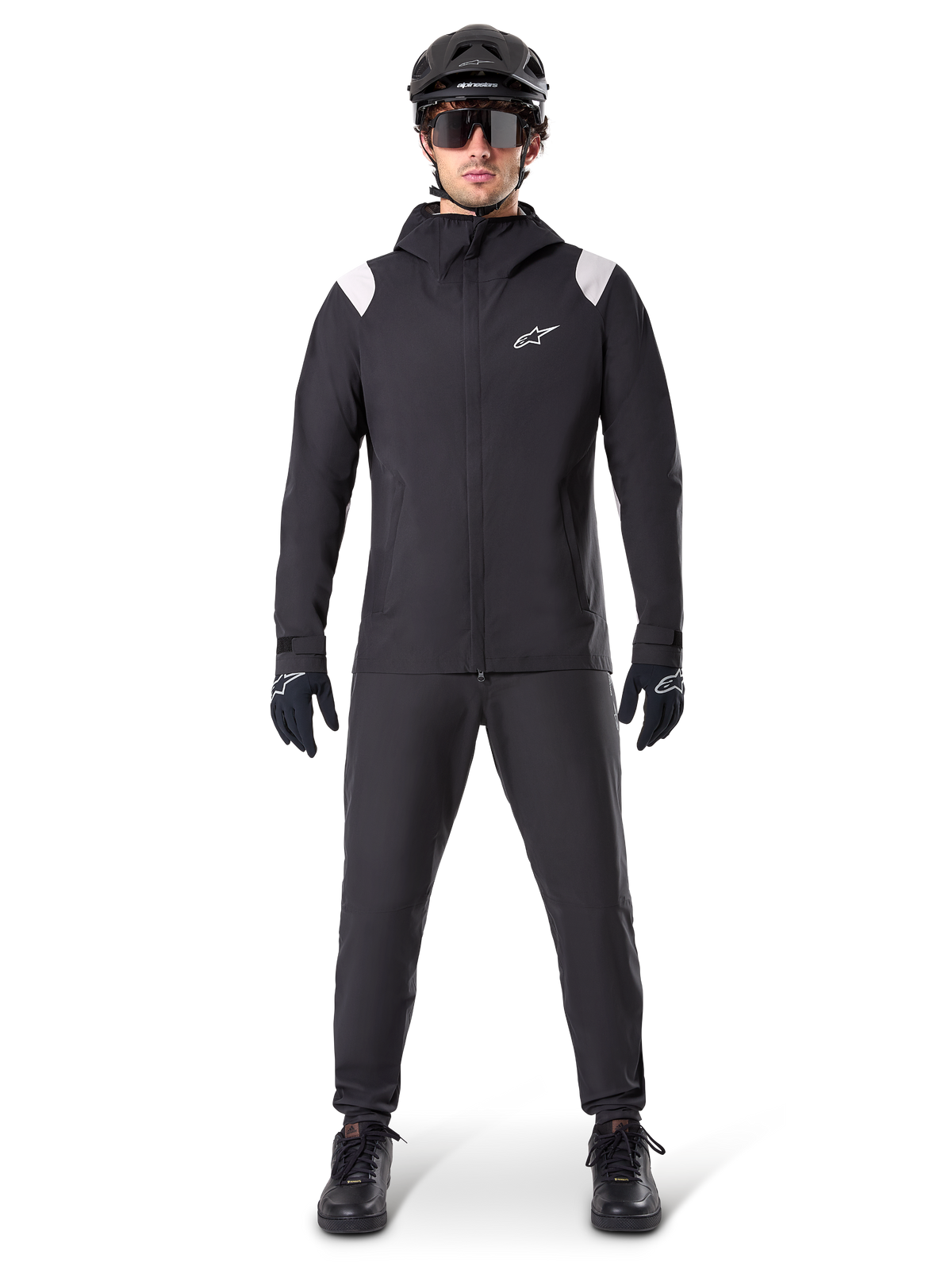 Alpinestars A-Dura Rain Jacket, Mountain Bike Rain Jacket, Black with white shoulder accents and white logo on chest, worn with black pants, black helmet, sunglasses, and gloves, coordinated mountain biking gear for wet weather