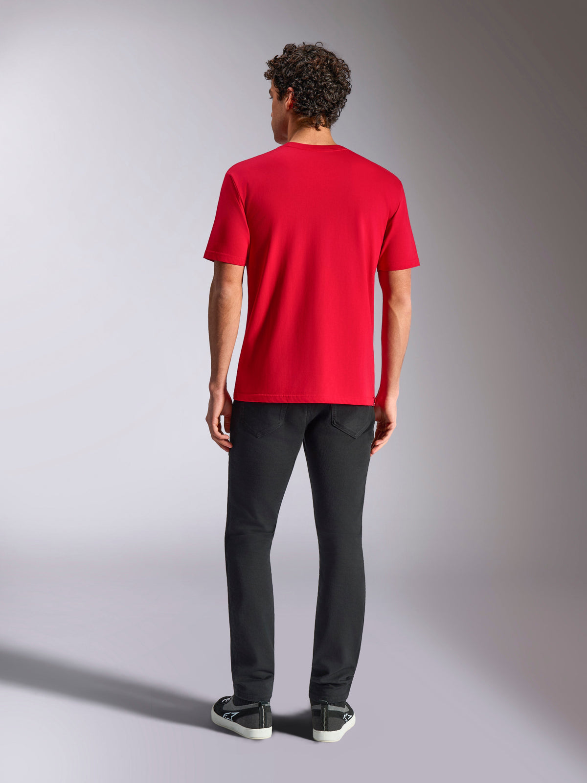 Alpinestars Ride 4.0 CSF Tee, czerwona koszulka z krótkim rękawem, widok z tyłu, noszona z czarnymi spodniami i czarnymi sneakersami, casualowy styl motorsport streetwear