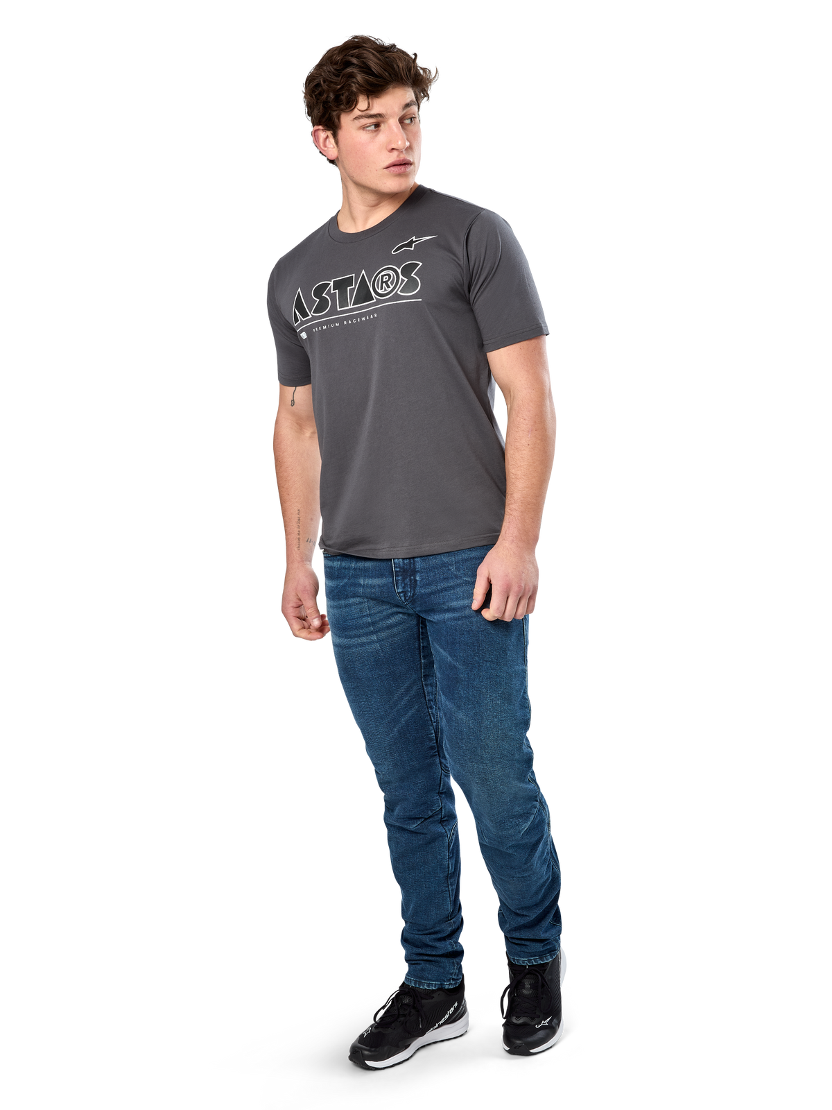 Alpinestars Cereal CSF Tee, Short Sleeve T-Shirt, Charcoal, White Geometric Astars Text Logo, Casual Motorsport Streetwear worn with blue jeans and black sneakers
