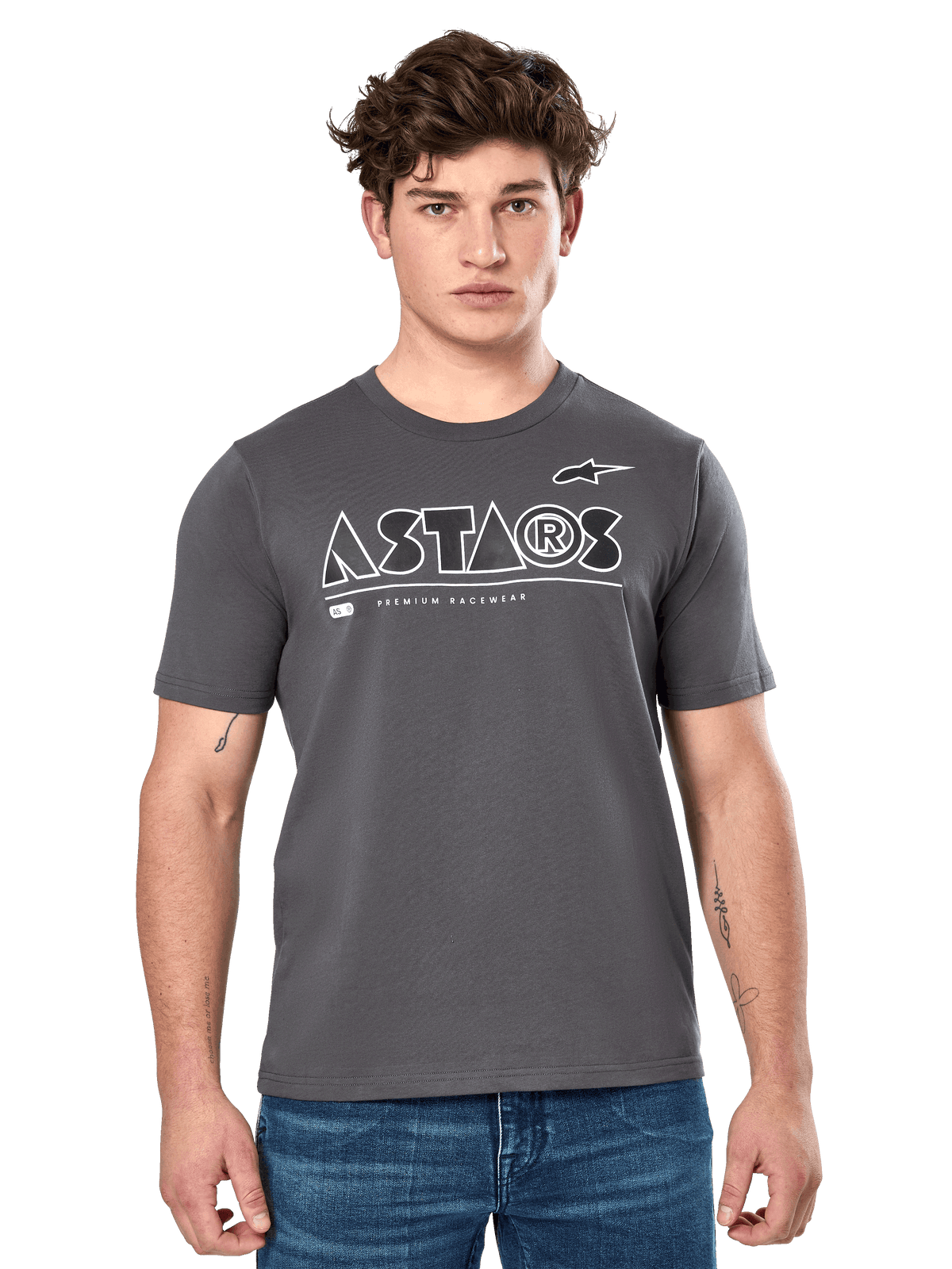 Alpinestars Cereal CSF Tee, Charcoal Gray Short Sleeve T-Shirt, worn by a male model with blue jeans, white ASTARS geometric logo and 'Premium Racewear' text, casual motorsport-inspired lifestyle apparel