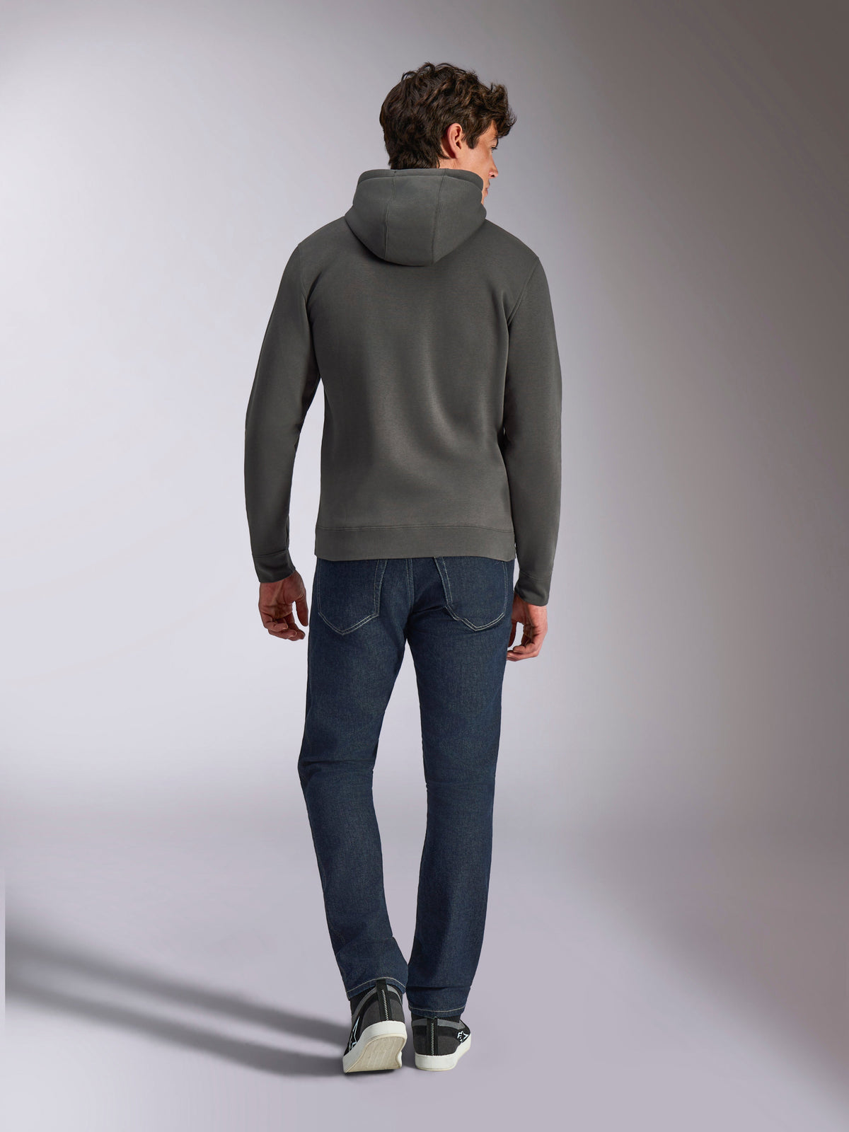 Alpinestars Ellipsoid Hoodie, Gunmetal gray pullover hoodie, back view, worn by model with dark denim jeans and black sneakers, casual motorsport-inspired streetwear