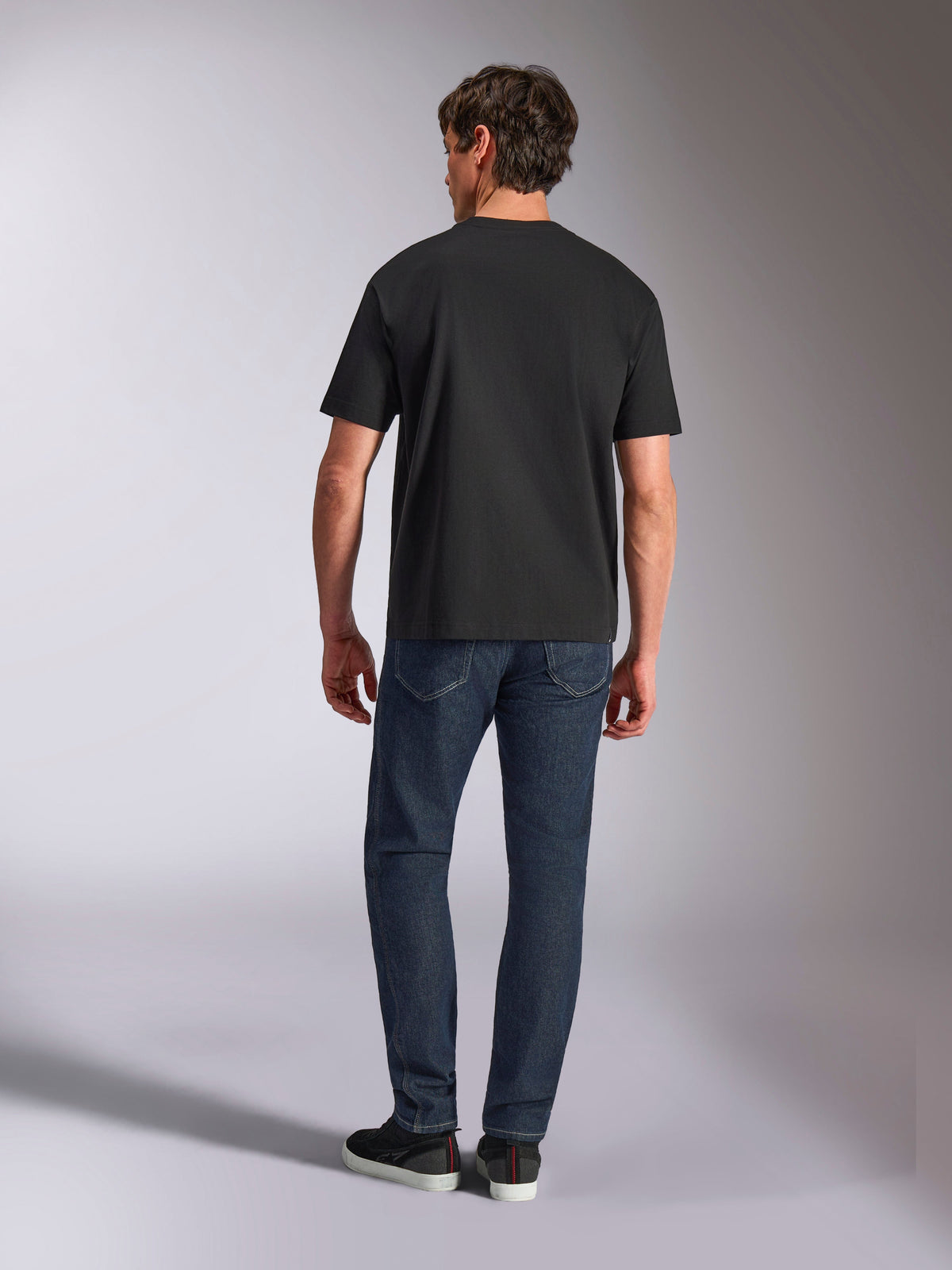 Alpinestars Aplomb Oversized CSF Tee, Short Sleeve T-Shirt, Black, back view on model wearing relaxed fit tee with denim jeans, casual motorsport streetwear