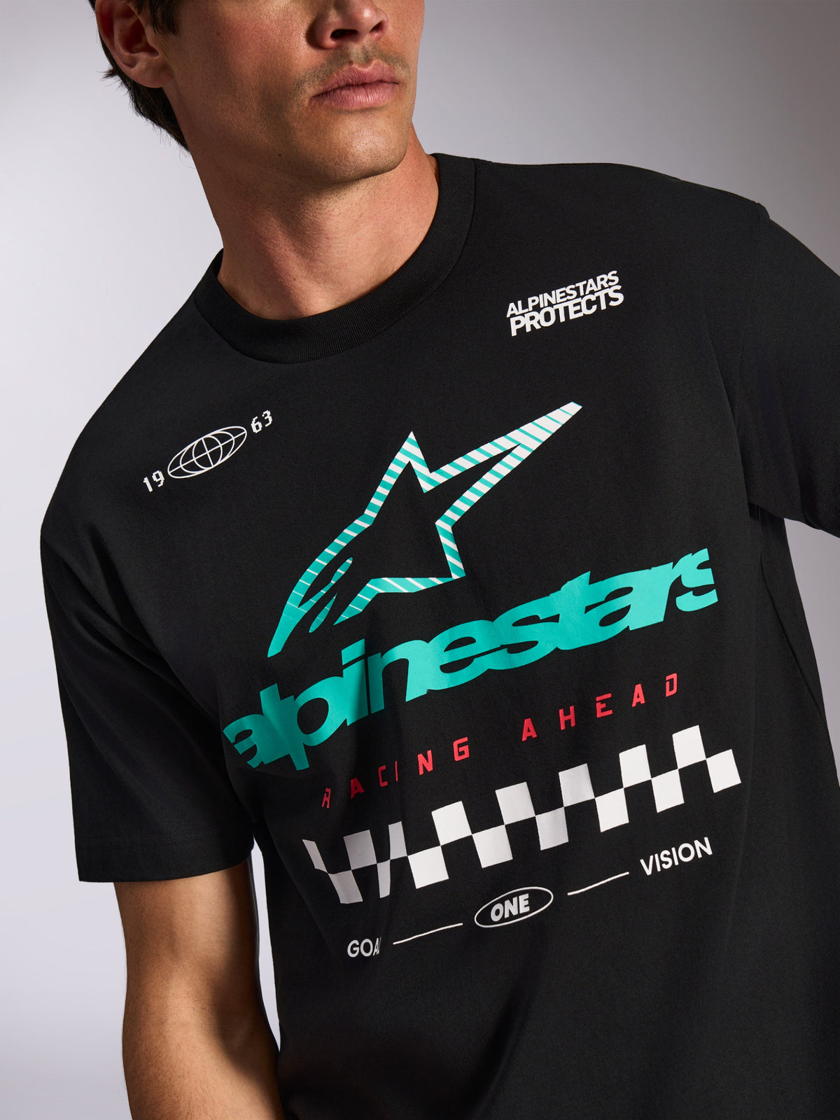 Alpinestars Aplomb Oversized CSF Tee, Short Sleeve T-Shirt, Black, Teal and white striped Astars logo, red 'Racing Ahead' text with checkered flag pattern, casual motorsport streetwear