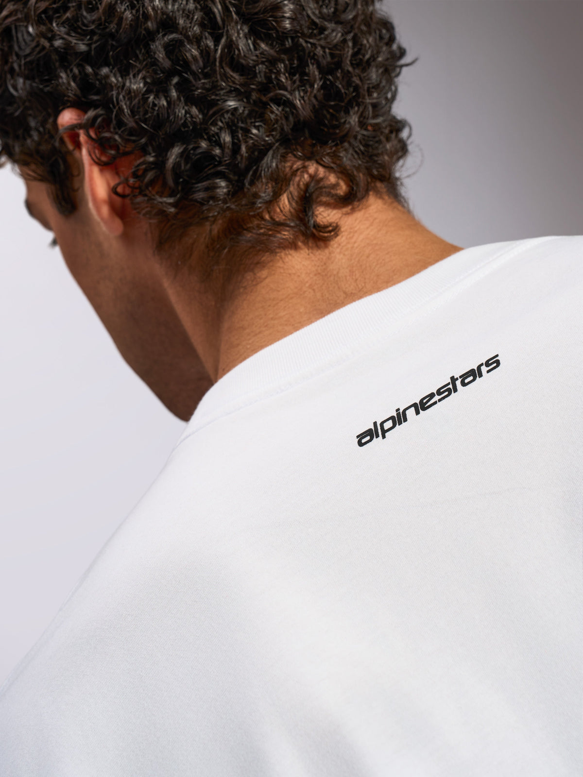 Alpinestars Focused Oversized CSF Tee, Short Sleeve T-Shirt, White, close-up of back neck area featuring small black Alpinestars wordmark logo, casual motorsport-inspired design