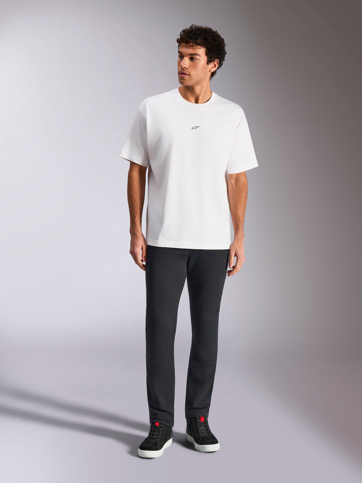 Alpinestars Focused Oversized CSF Tee, Short Sleeve T-Shirt, White, small black Astars logo on chest, casual streetwear style, worn by model with dark pants and black high-top sneakers