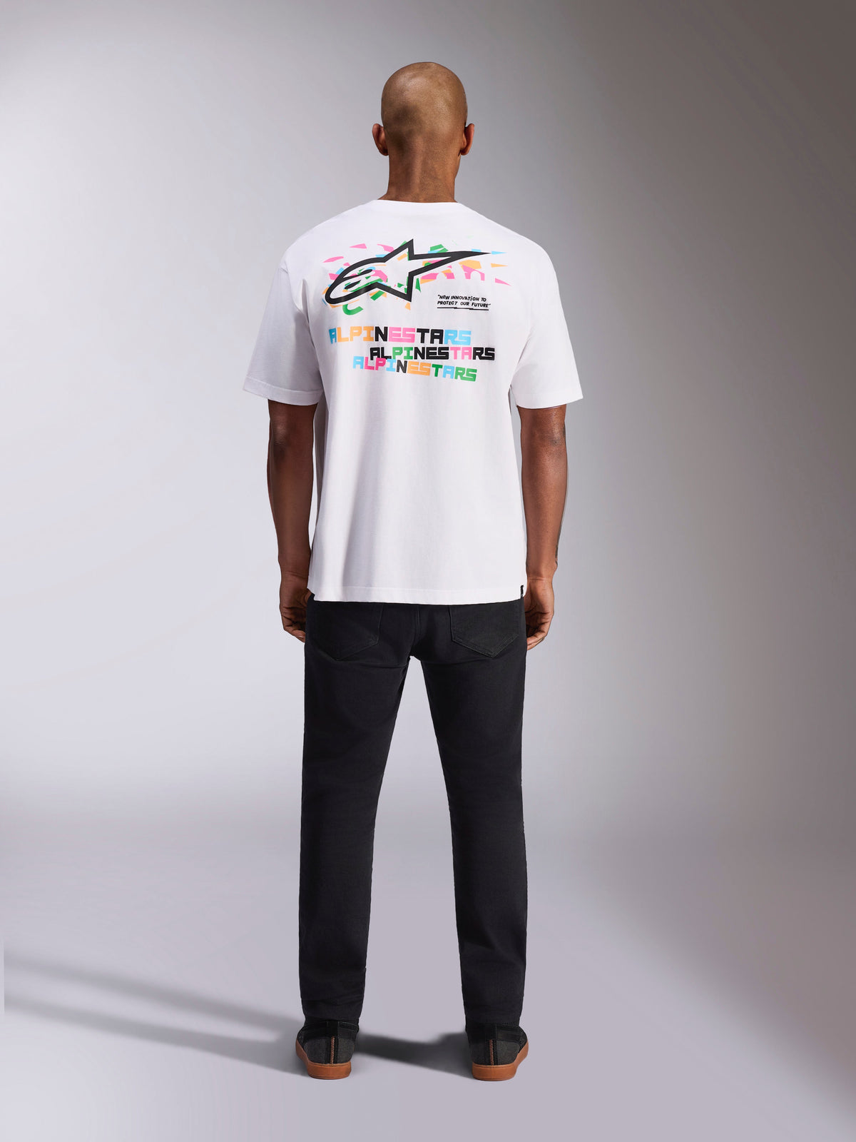 Alpinestars Wild Oversized CSF Tee, Short Sleeve T-Shirt, White, back view showing vibrant multicolor Astars logo and repeated typography, casual motorsport-inspired streetwear