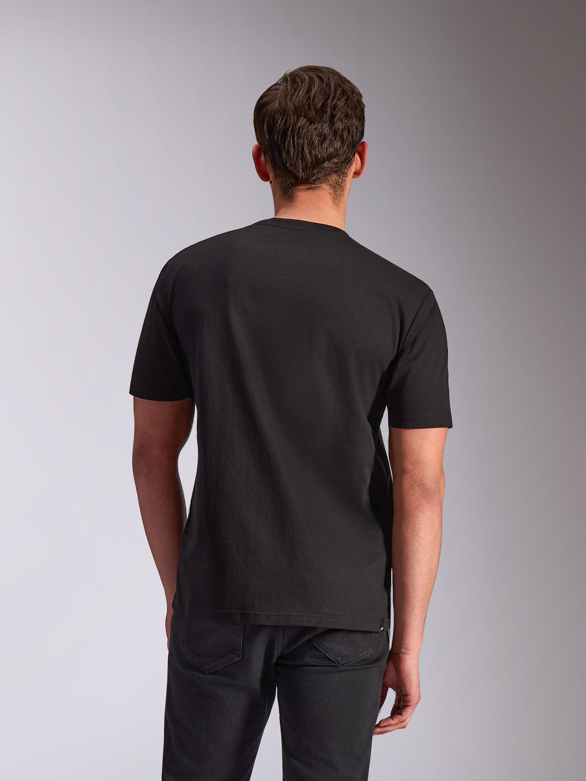 Alpinestars Trifecta CSF Tee, koszulka z krótkim rękawem, czarna, widok z tyłu na modelu, codzienna odzież uliczna inspirowana sportami motorowymi