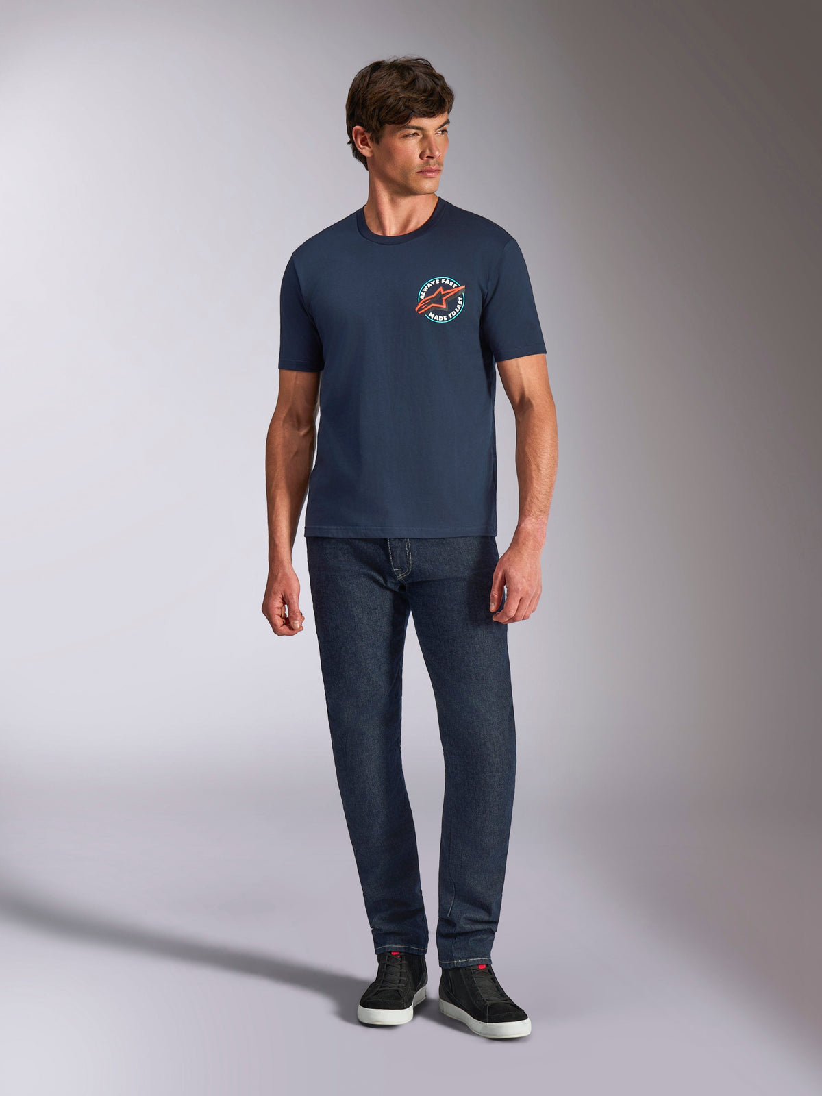 Alpinestars Aorbit CSF Tee, Short Sleeve T-Shirt, Navy, circular chest graphic with Always Fast Made to Last text, worn with dark jeans and sneakers, casual motorsport lifestyle wear