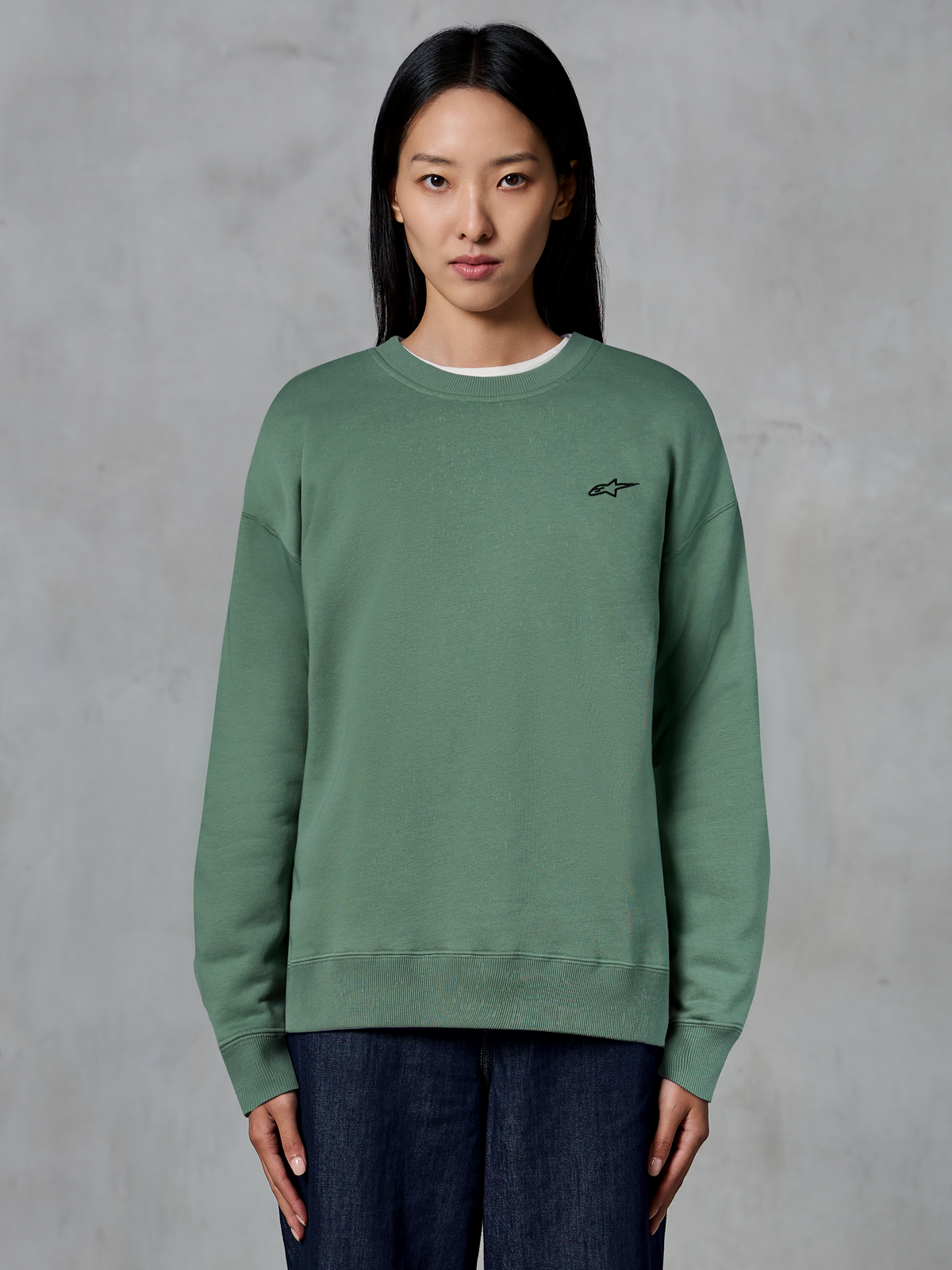 Alpinestars Essentials Ageless Crew, Crewneck Sweatshirt, Cactus Green, worn by a model, small black logo on the chest, ribbed collar, cuffs, and hem, casual motorsport streetwear