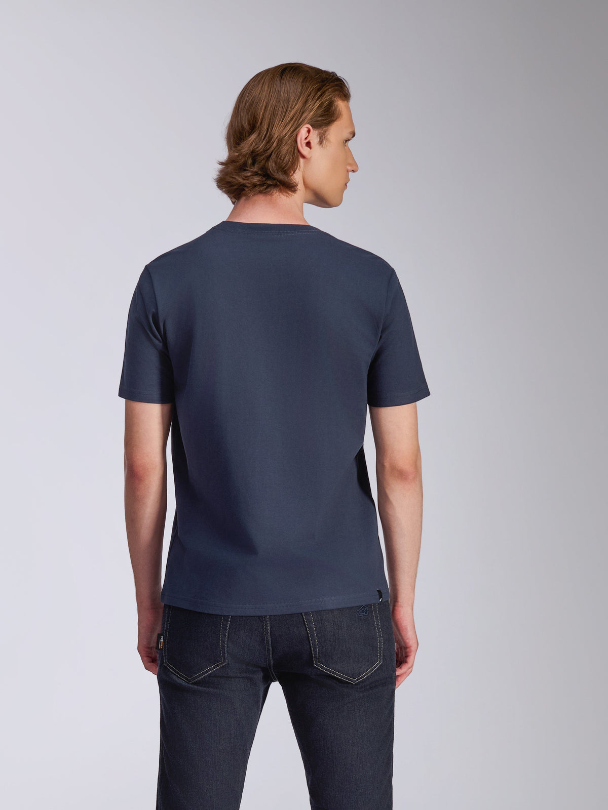 Alpinestars Fasting CSF Tee, Short Sleeve T-Shirt, Navy Blue, back view, worn by model with dark jeans, casual motorsport-inspired streetwear