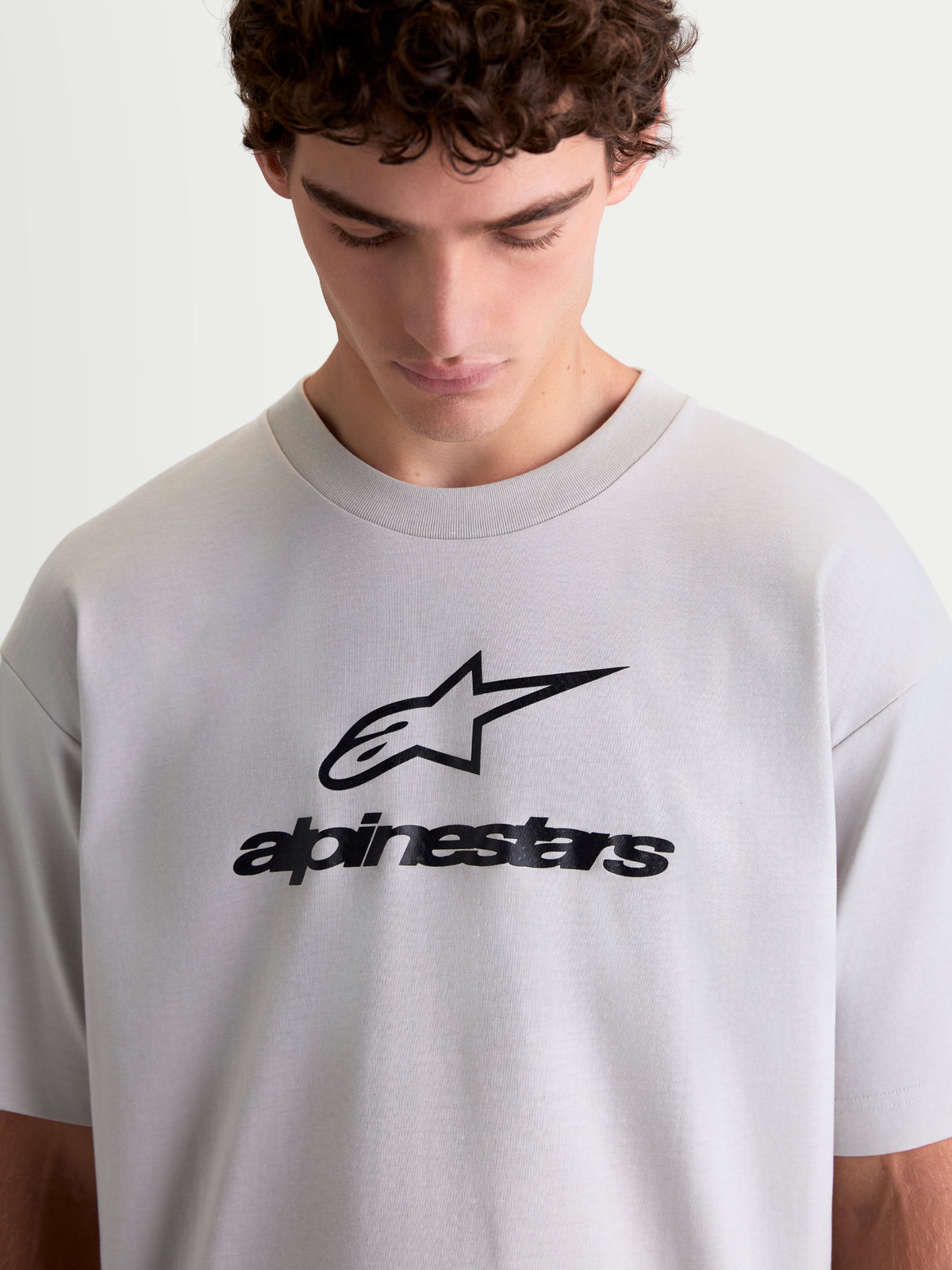 Alpinestars Prelude Oversized CSF Tee, męska koszulka lifestyle o luźnym kroju, szary kolor cementowy, czarne logo Astars i napis Alpinestars na klatce piersiowej, krótki rękaw, miękka bawełna z poliestrem.