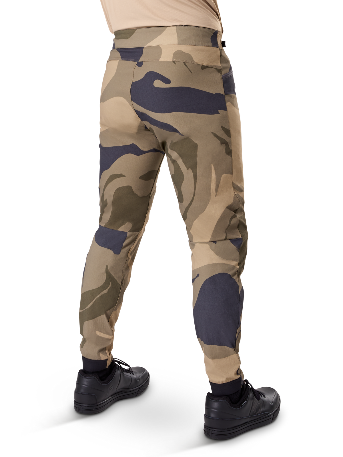 Alpinestars A-Dura Camo Pant, MTB Pants, Brown camouflage pattern with tan and dark grey accents, rear view shown with black sneakers, featuring tapered legs and elasticated cuffs, durable 2-way stretch fabric for mountain biking