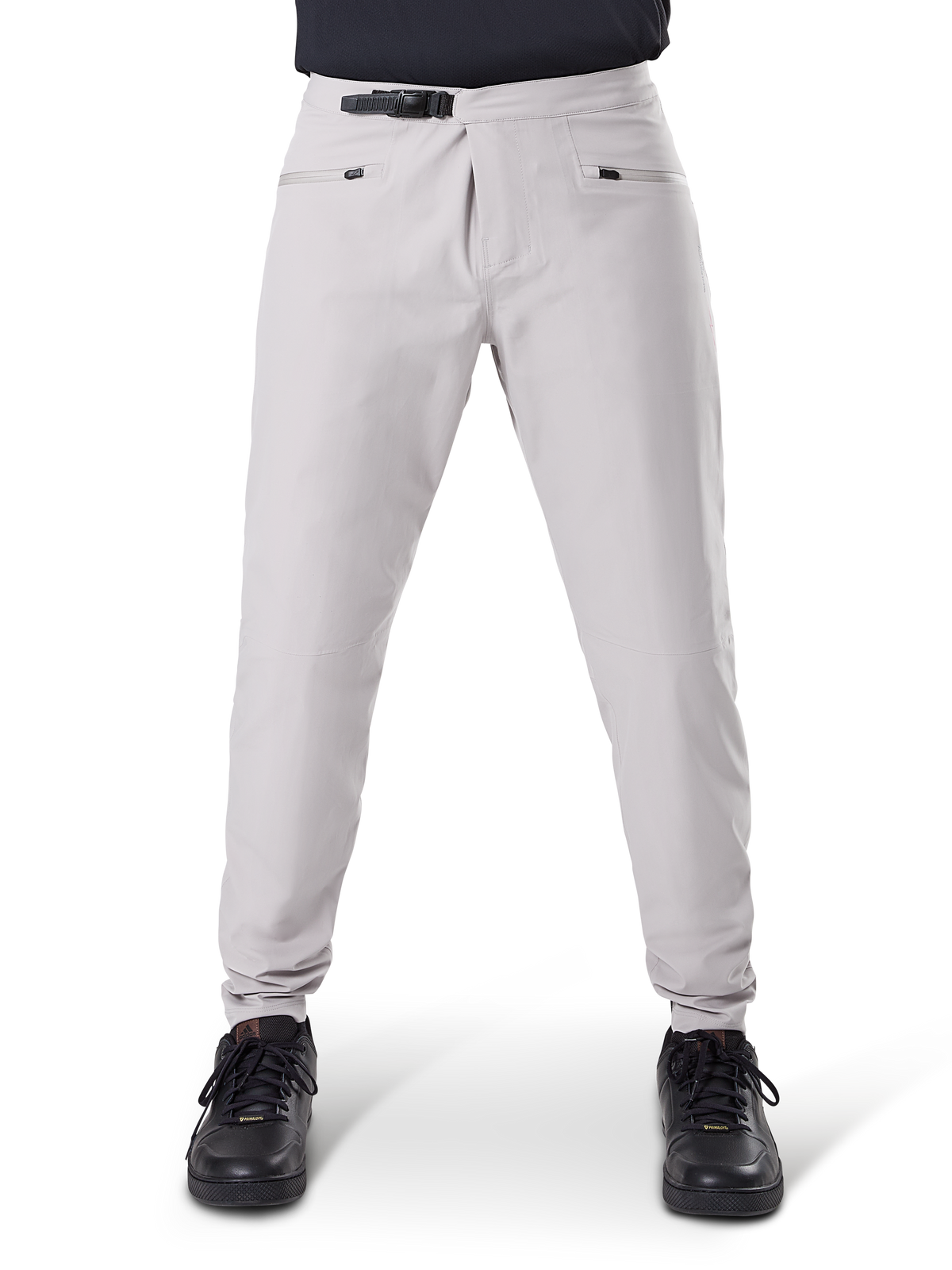 Alpinestars A-Dura Waterproof Pants, MTB Cycling Pants, Titanium Gray, front view, featuring a black ratchet waist closure and dual zippered pockets, elasticated cuffs, worn with black sneakers, technical waterproof gear for mountain biking