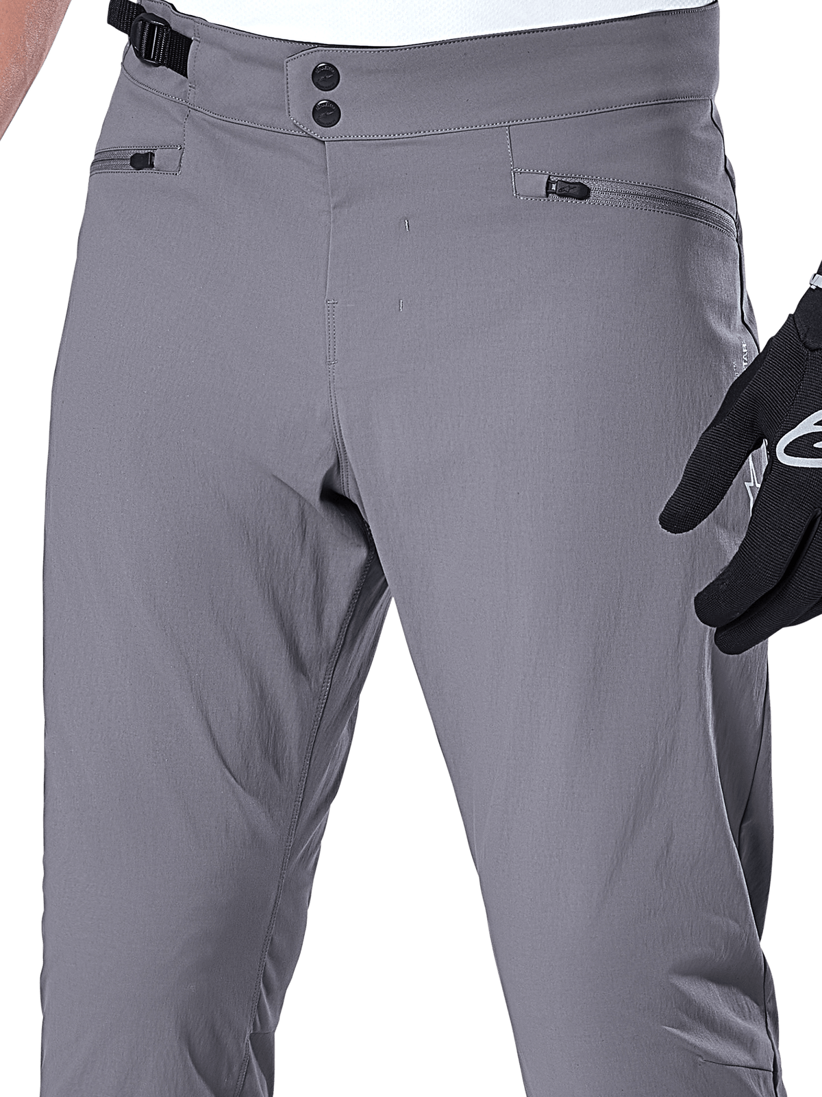 Alpinestars A-Dura Pants, spodnie MTB, ciemnoszare, zbliżenie na obszar talii z podwójnym zapięciem na zatrzaski, boczną regulacją i kieszeniami zapinanymi na zamek, wytrzymały elastyczny materiał do kolarstwa górskiego