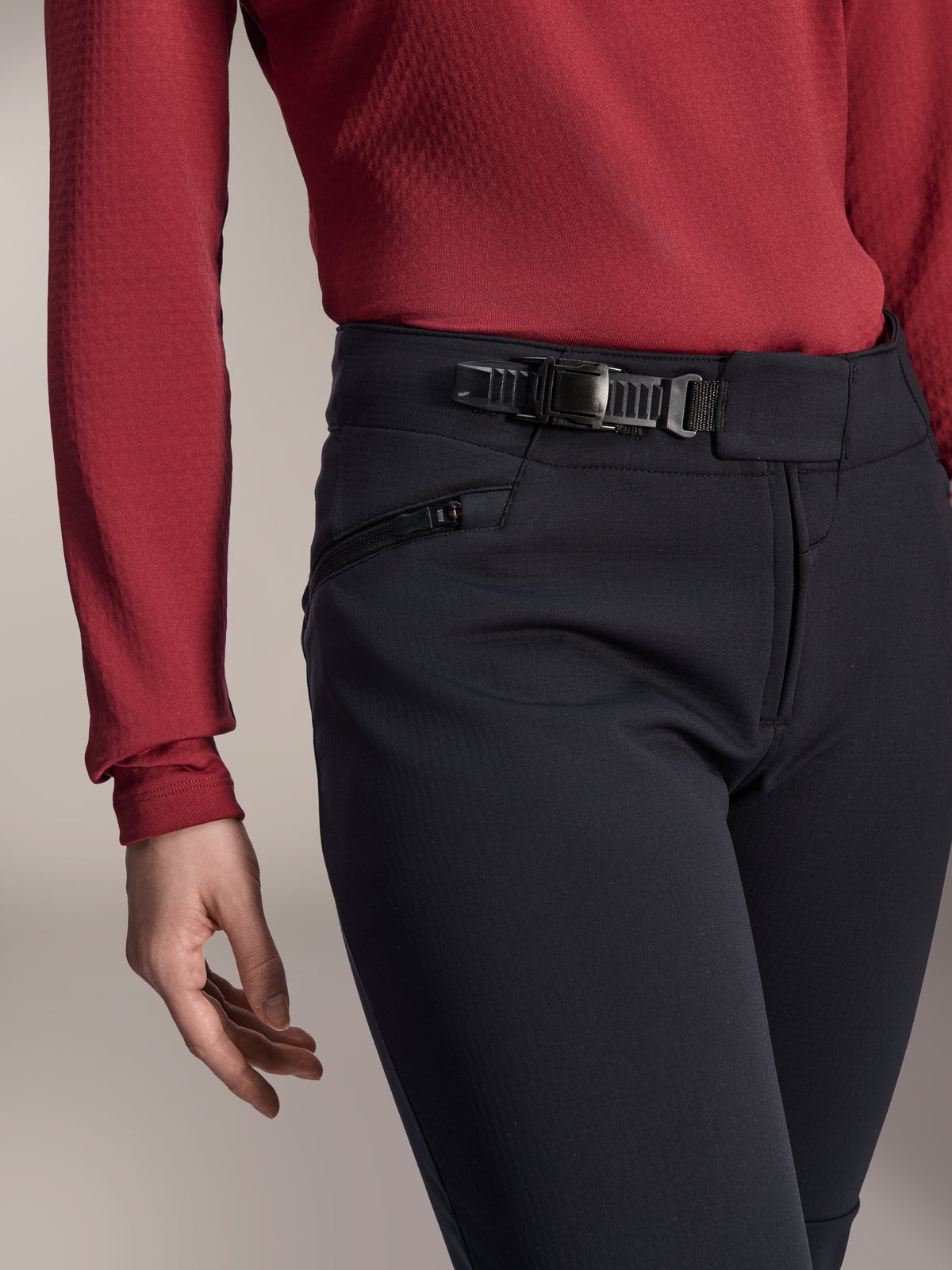 Alpinestars Stella A-Dura Thermal Pant, Women's MTB Pants, Black, close-up shot showing the ratchet closure system on the waistband and zippered side pocket, worn with a dark red long-sleeve top, durable gear for cold-weather trail riding