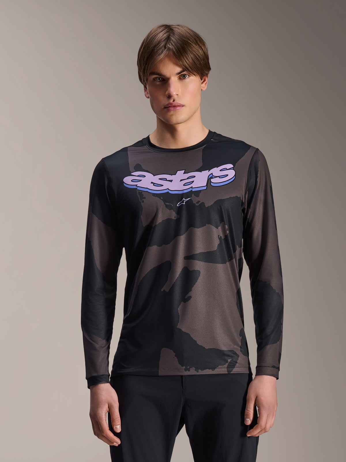 Alpinestars A-Dura Hollow Camo Long Sleeve Jersey, MTB Mountain Bike Jersey, Black and Gray Camouflage Pattern, Purple 'astars' graphic on chest, worn by model with black pants, casual performance design