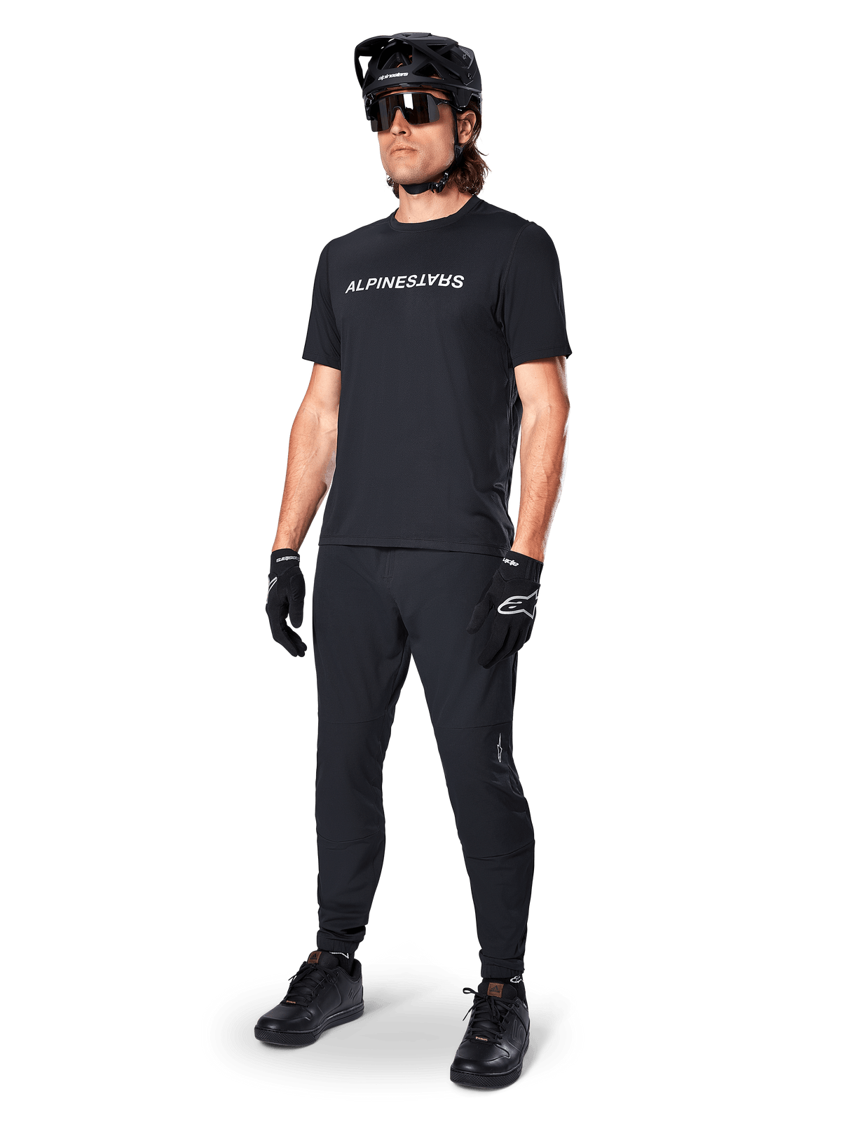 Alpinestars A-Dura Switch Jersey, Black short sleeve MTB top with white chest logo, worn by a male rider in full kit.