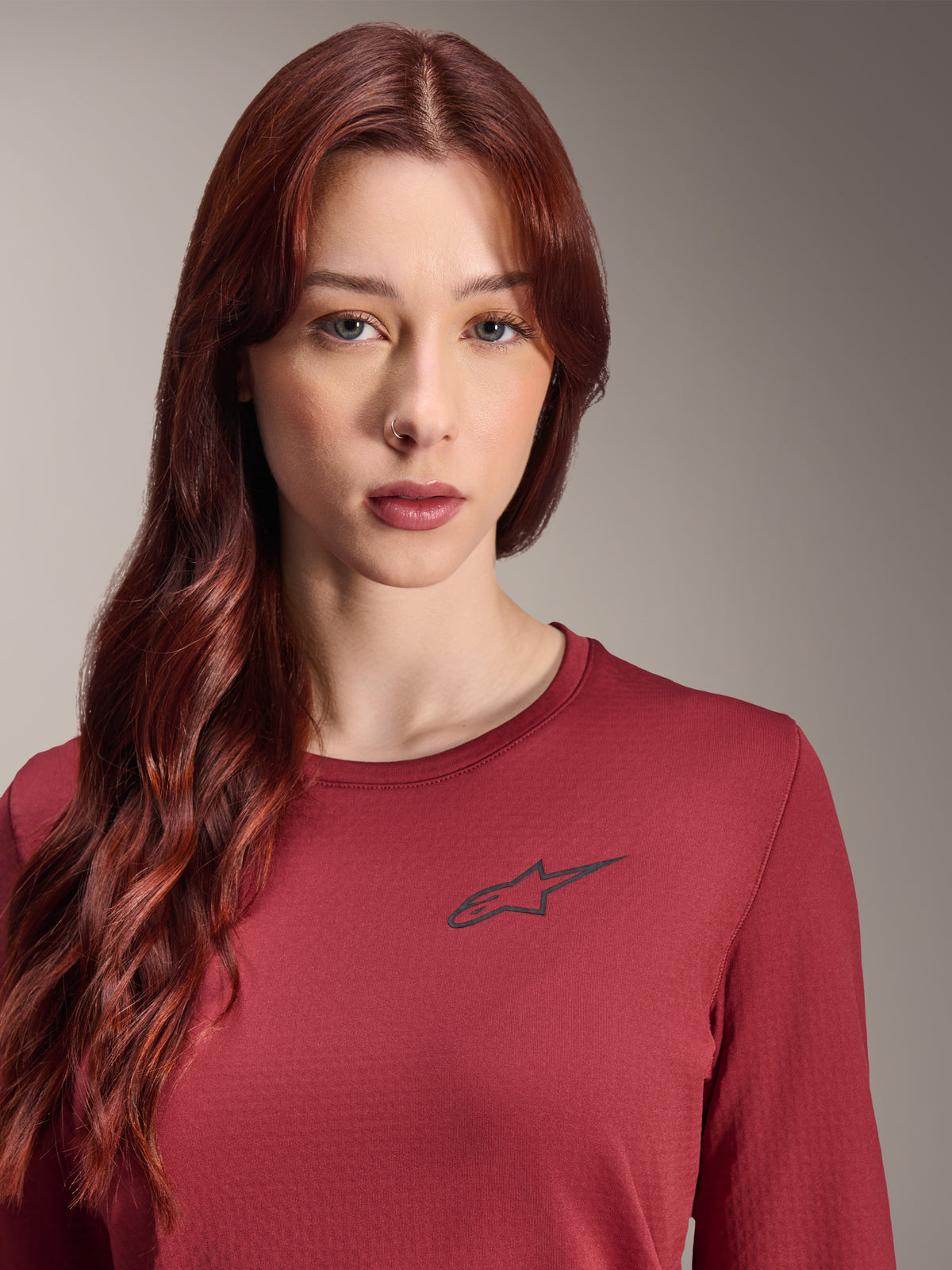 Alpinestars Stella A-Dura Thermal Jersey, Women's Long Sleeve MTB Jersey, Burgundy, close-up view featuring a black star logo on the chest, insulated technical gear for cold-weather mountain biking
