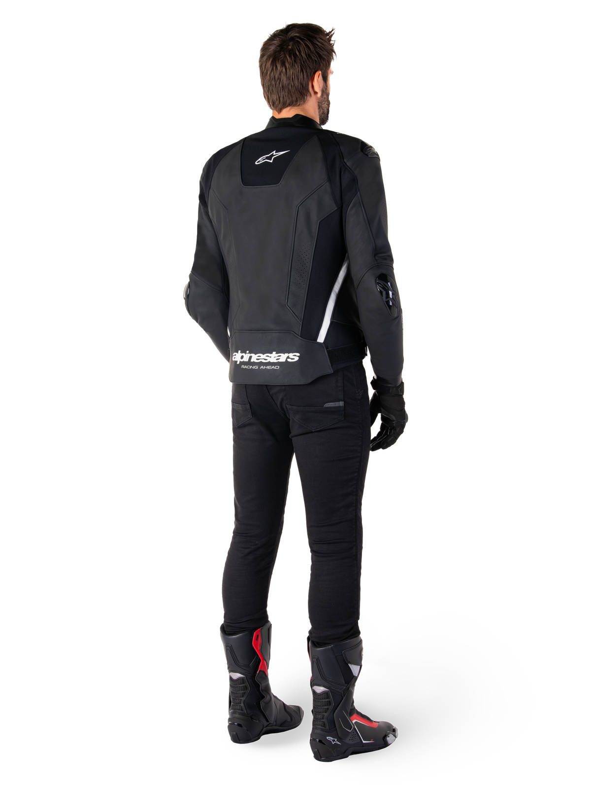 Alpinestars Missile V3 Leather Jacket, Black and White, rear view on rider, featuring bold white Alpinestars branding on the lower back and small logo on the upper back, worn with black pants and racing boots, premium leather construction for motorcycle racing