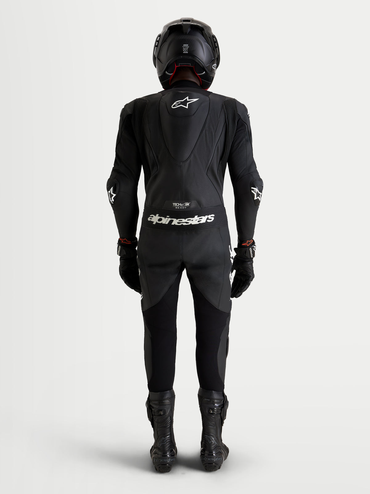 Alpinestars Missile V3 Leather Suit - 1 Piece, Black, on-model rear view showcasing the aerodynamic speed hump and race-grade leather construction for motorcycle racing