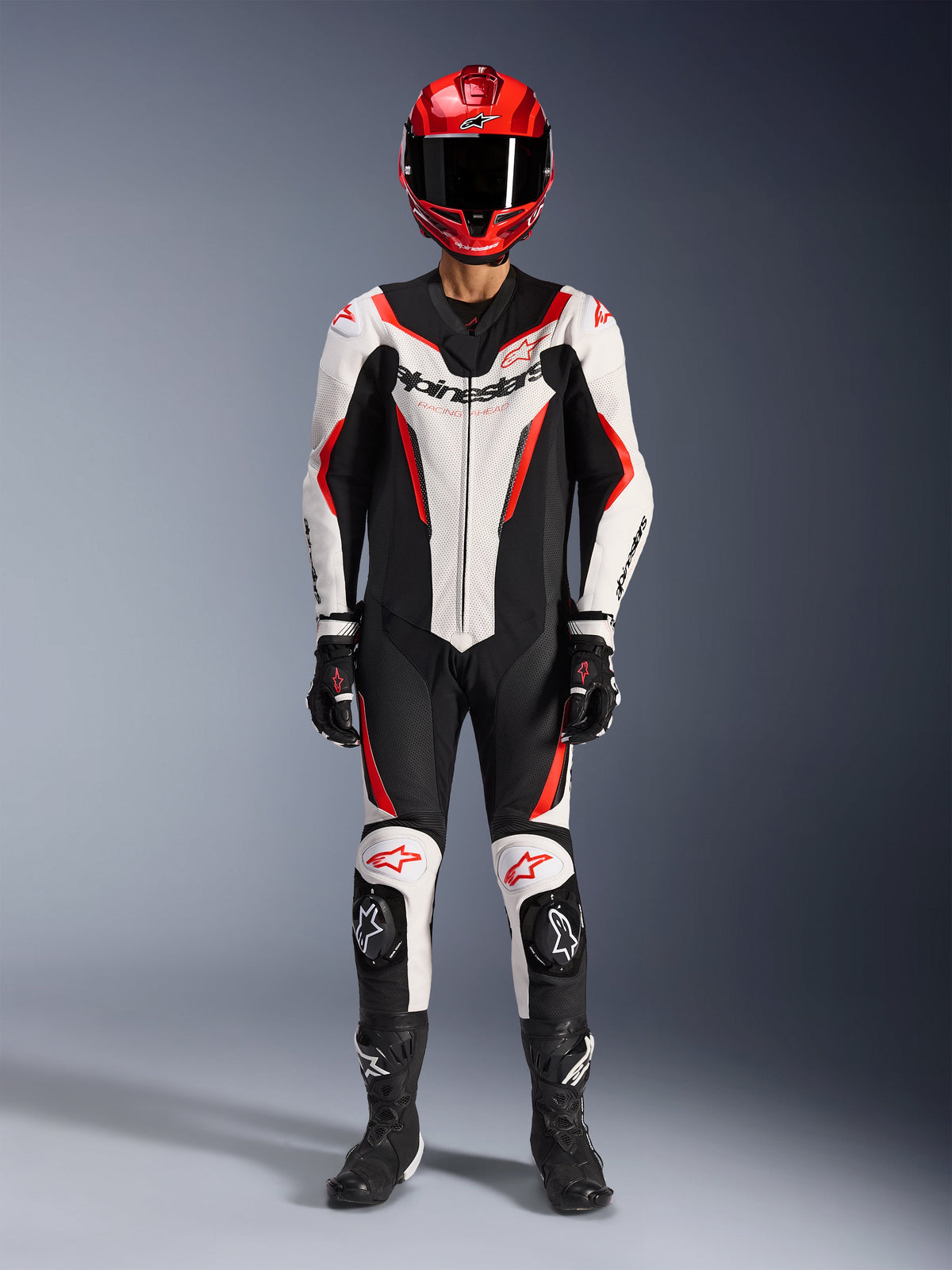 Alpinestars GP Force V2 Leather Suit - 1Piece, White Black and Red Fluo, full racing gear including red helmet, black gloves and boots, featuring aerodynamic design and Alpinestars branding on chest and knees
