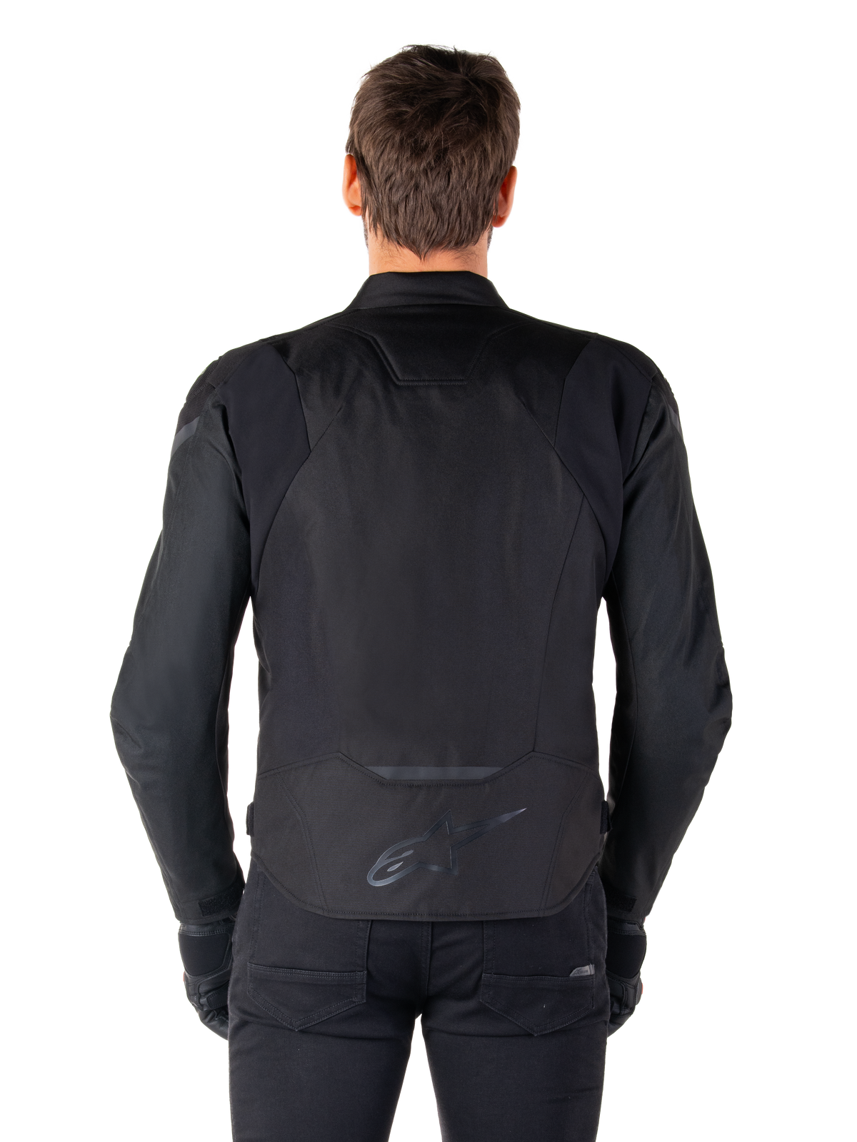 Alpinestars T-Jaws V4 Waterproof Jacket, tekstylna kurtka motocyklowa, czarna, widok z tyłu pokazujący logo Alpinestars w dolnej części pleców, sportowy krój do jazdy szosowej