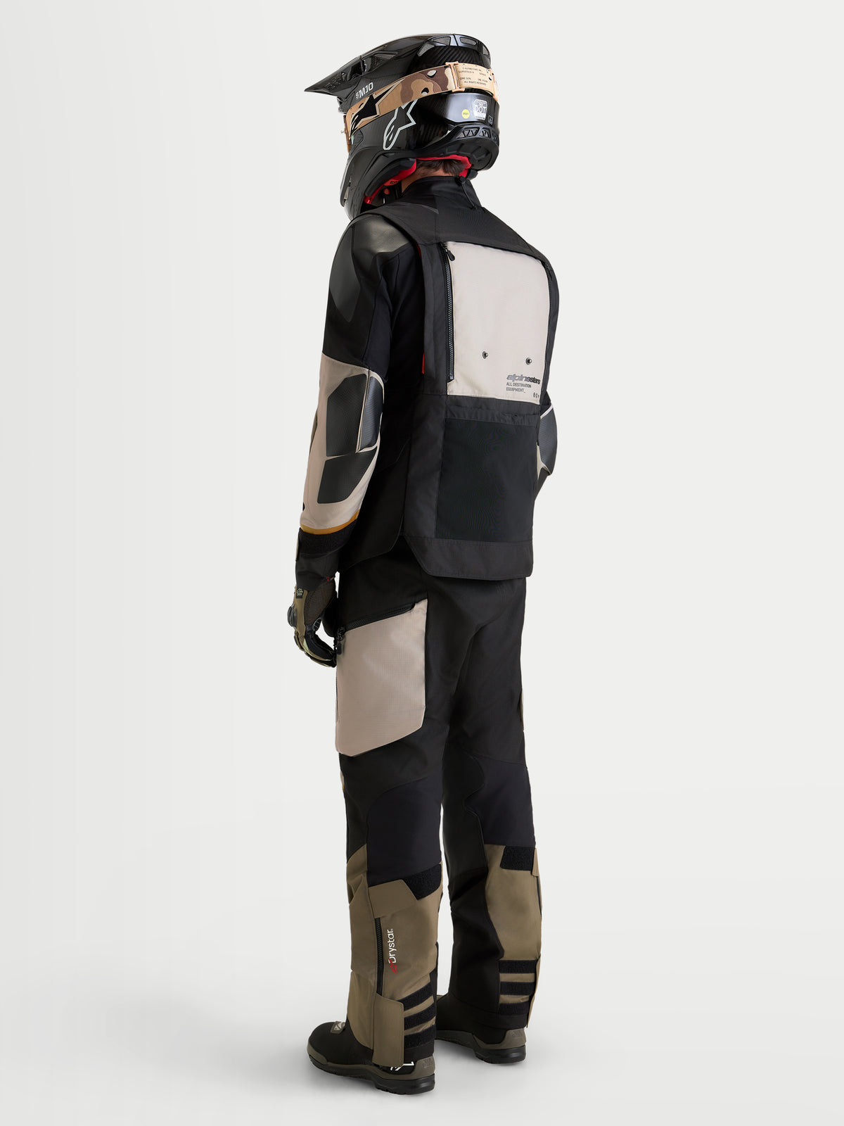 Alpinestars Harok V2 Drystar Gear Set, kurtka i spodnie motocyklowe adventure w kolorze czarnym i khaki, widok z tyłu na modela w pasującym sprzęcie i kasku, wodoodporna odzież jeździecka na każdą pogodę