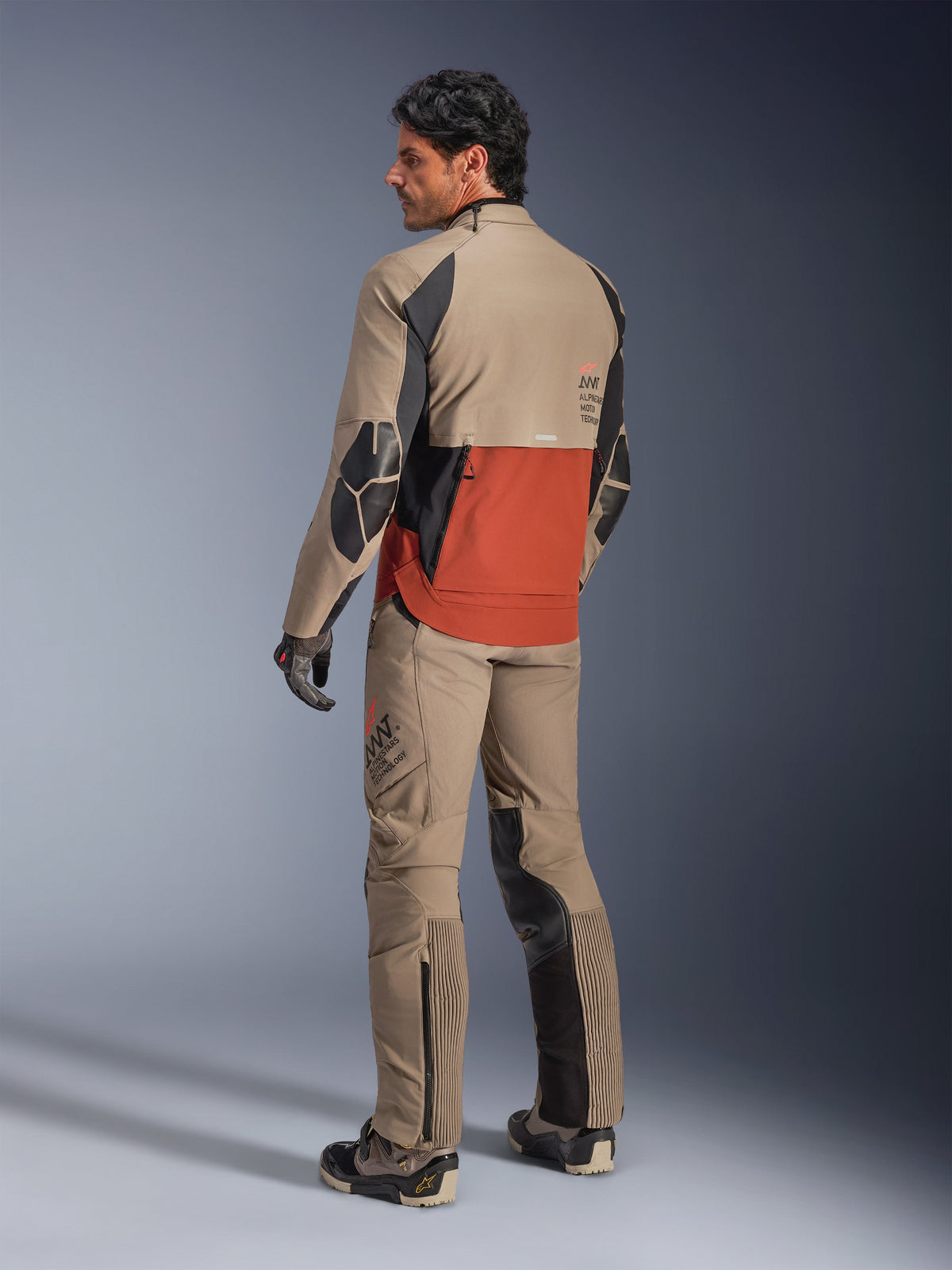 Alpinestars AMT-8 Stretch Drystar® XF Jacket, Adventure Motorcycle Jacket, Walnut Rust and Black, back view on model worn with matching adventure pants and boots, highly breathable textile gear for touring