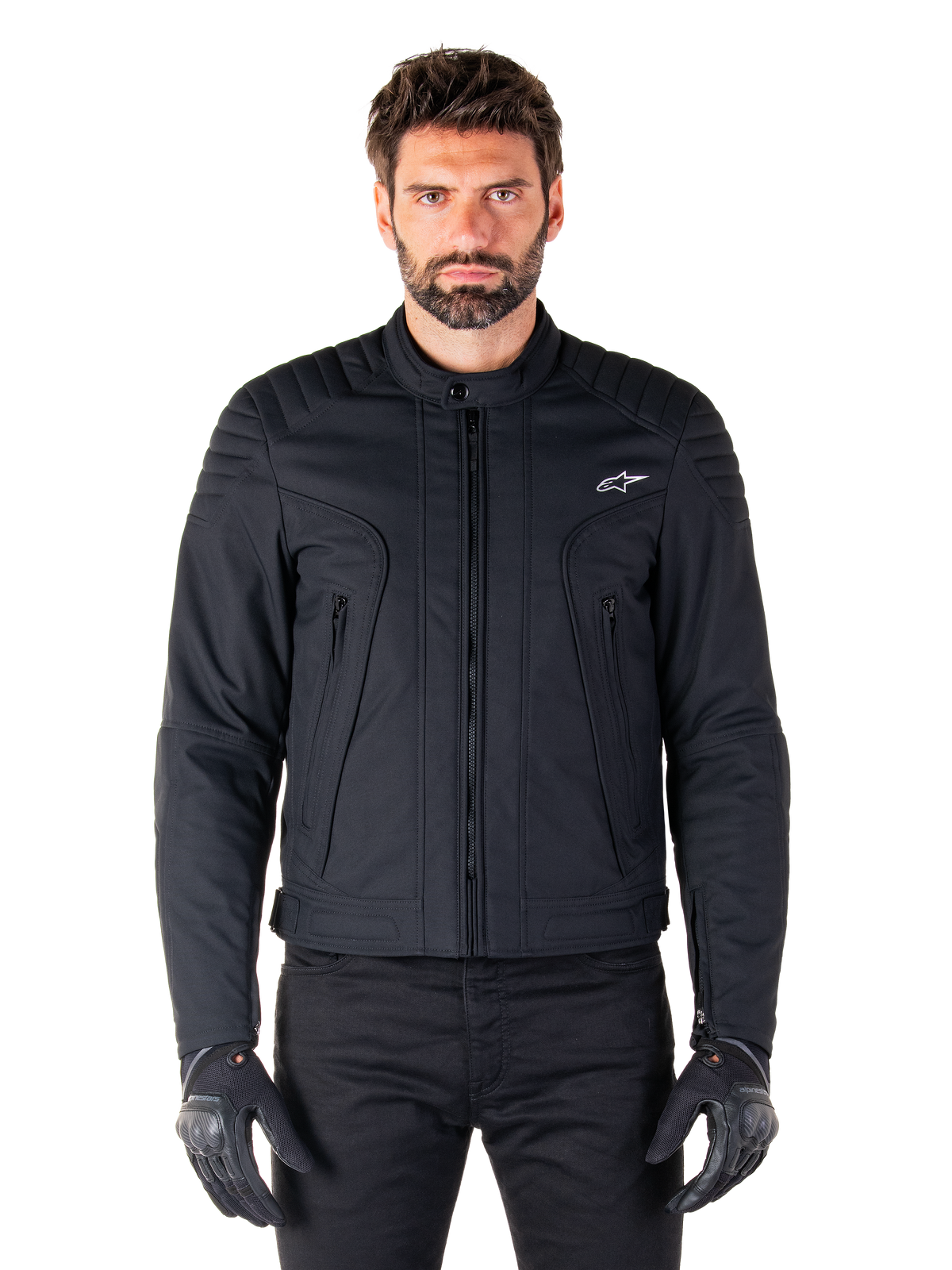 Alpinestars Clayton WR Jacket, czarna kurtka motocyklowa, prezentowana na modelu, pikowane detale na ramionach i techniczne grafiki, centralny zamek Vislon, pionowe kieszenie na suwak, małe białe logo na piersi, miejska odzież motocyklowa do użytku drogowego