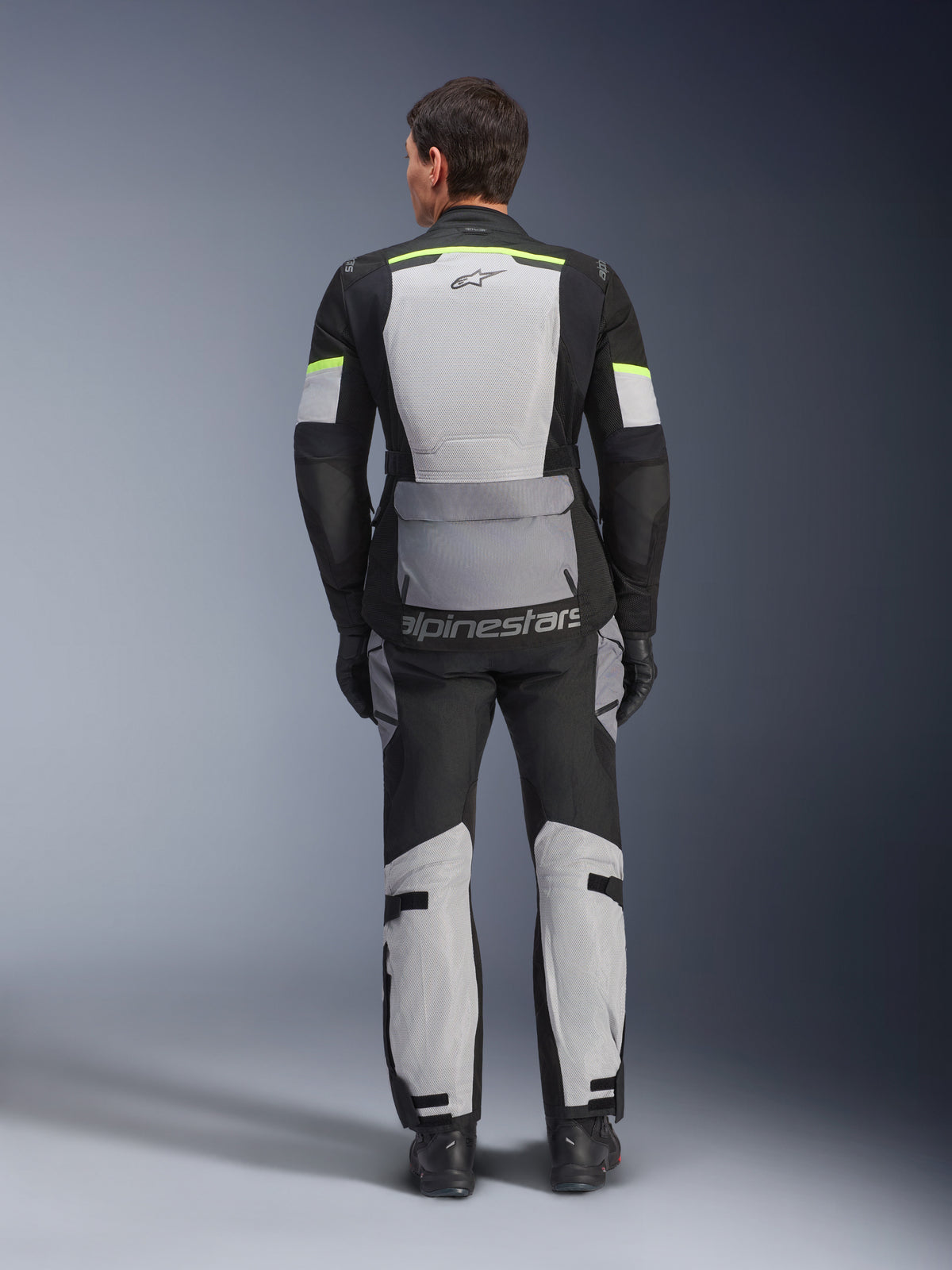 Alpinestars Andes Air Drystar® Jacket, Motorcycle Touring Jacket, Ice Gray, Dark Gray, and Black, rear view showing extensive mesh panels for ventilation, fluorescent yellow accents, and Alpinestars branding, worn with matching touring pants