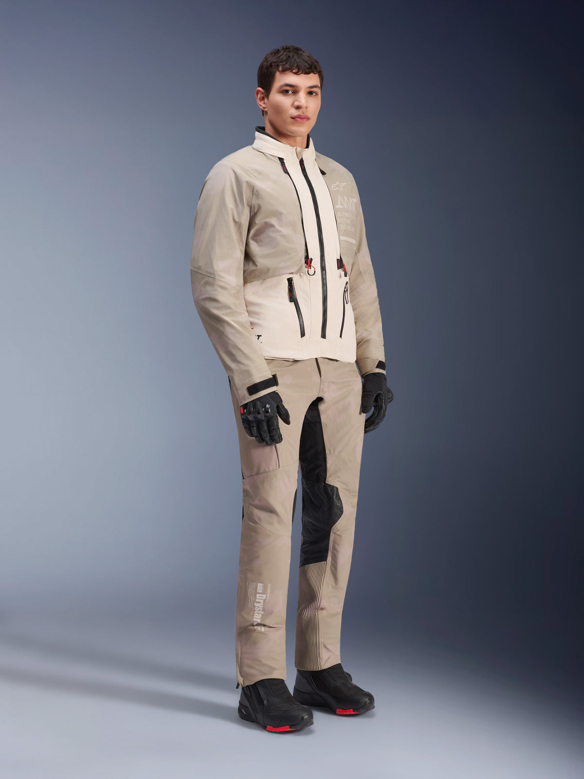 Alpinestars AMT-10LAB Drystar® XF Pants and matching jacket, Aluminum Camo adventure riding gear, complete outfit with black gloves and boots, featuring technical branding and modular protective panels, studio lifestyle shot