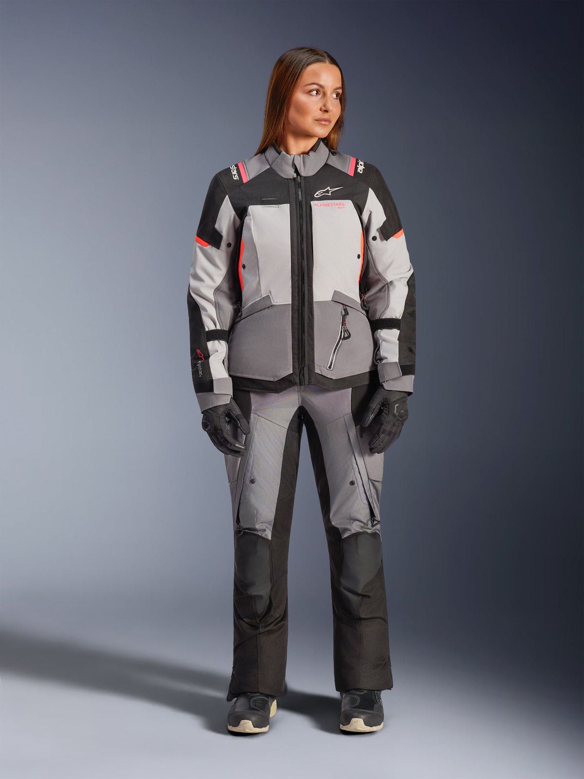 Alpinestars Stella Andes V4 Drystar® Jacket, women's adventure textile gear in gray and black with coral fluo accents.