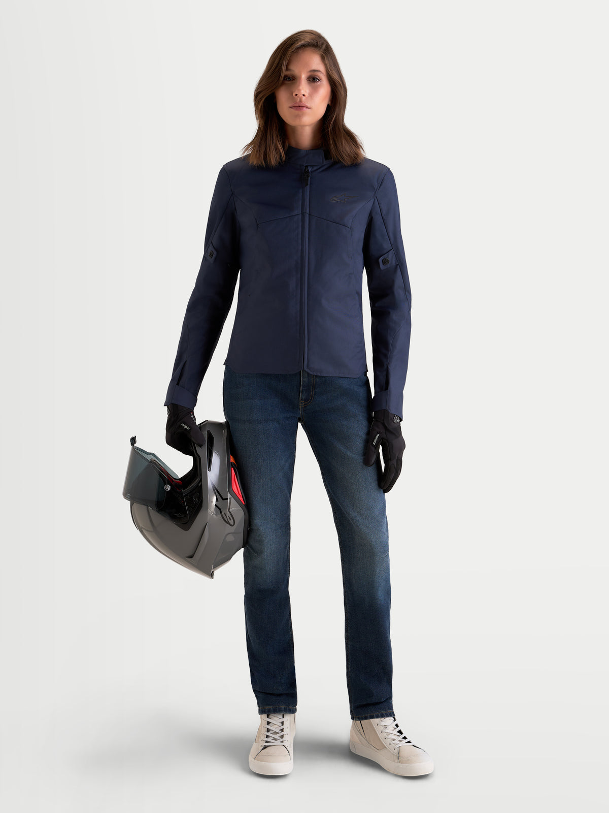 Alpinestars Stella C-1 Waterproof Jacket, women's urban contemporary motorcycle jacket in mood indigo blue, worn by a model holding a helmet, featuring durable polyfabric textile construction.