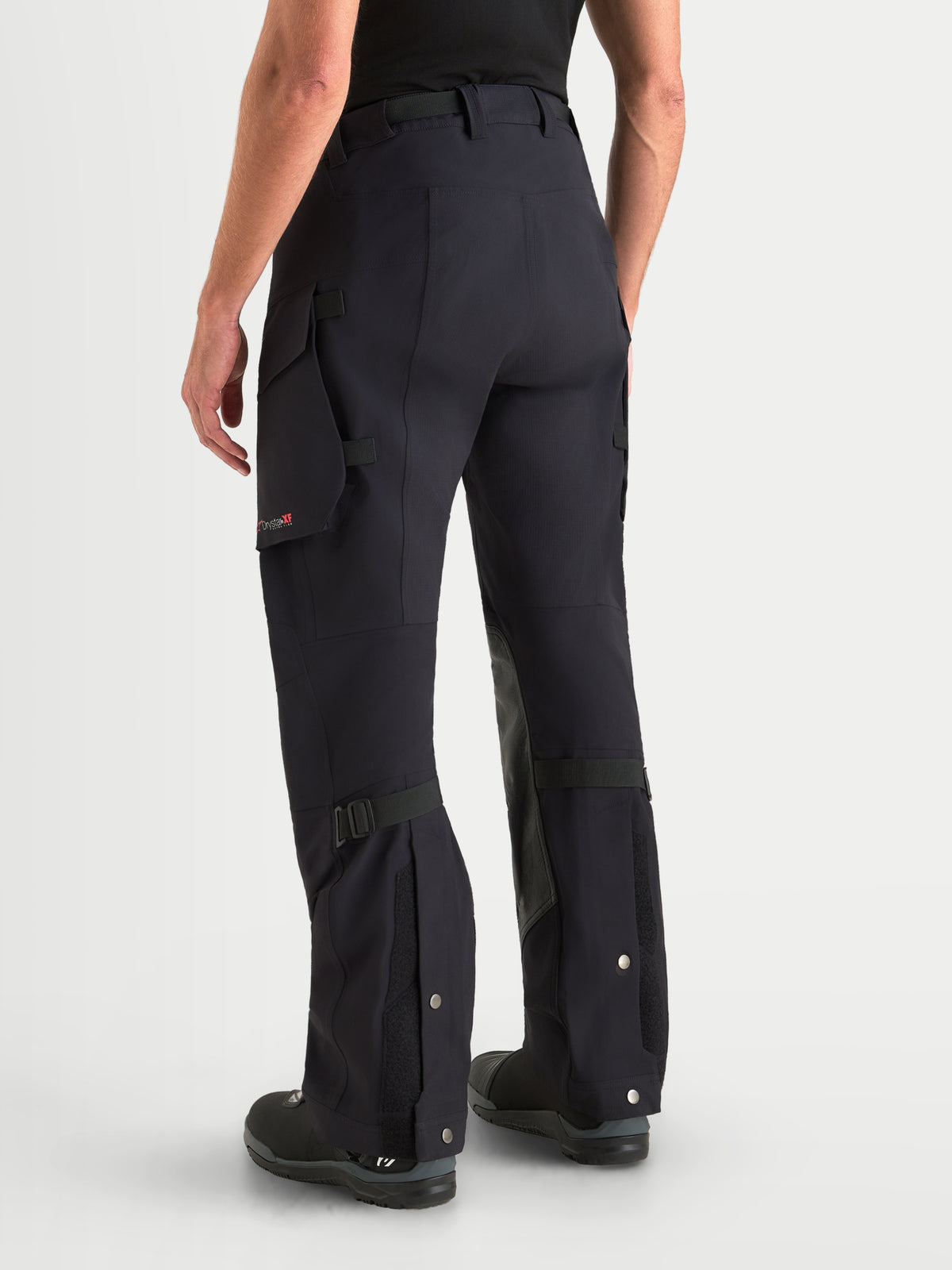Alpinestars Maxdura Drystar XF Laminated spodnie motocyklowe adventure męskie, czarne i ciemnoszare, widok z tyłu na model prezentujący kieszenie typu cargo, krój over-the-boot oraz laminowaną konstrukcję tekstylną