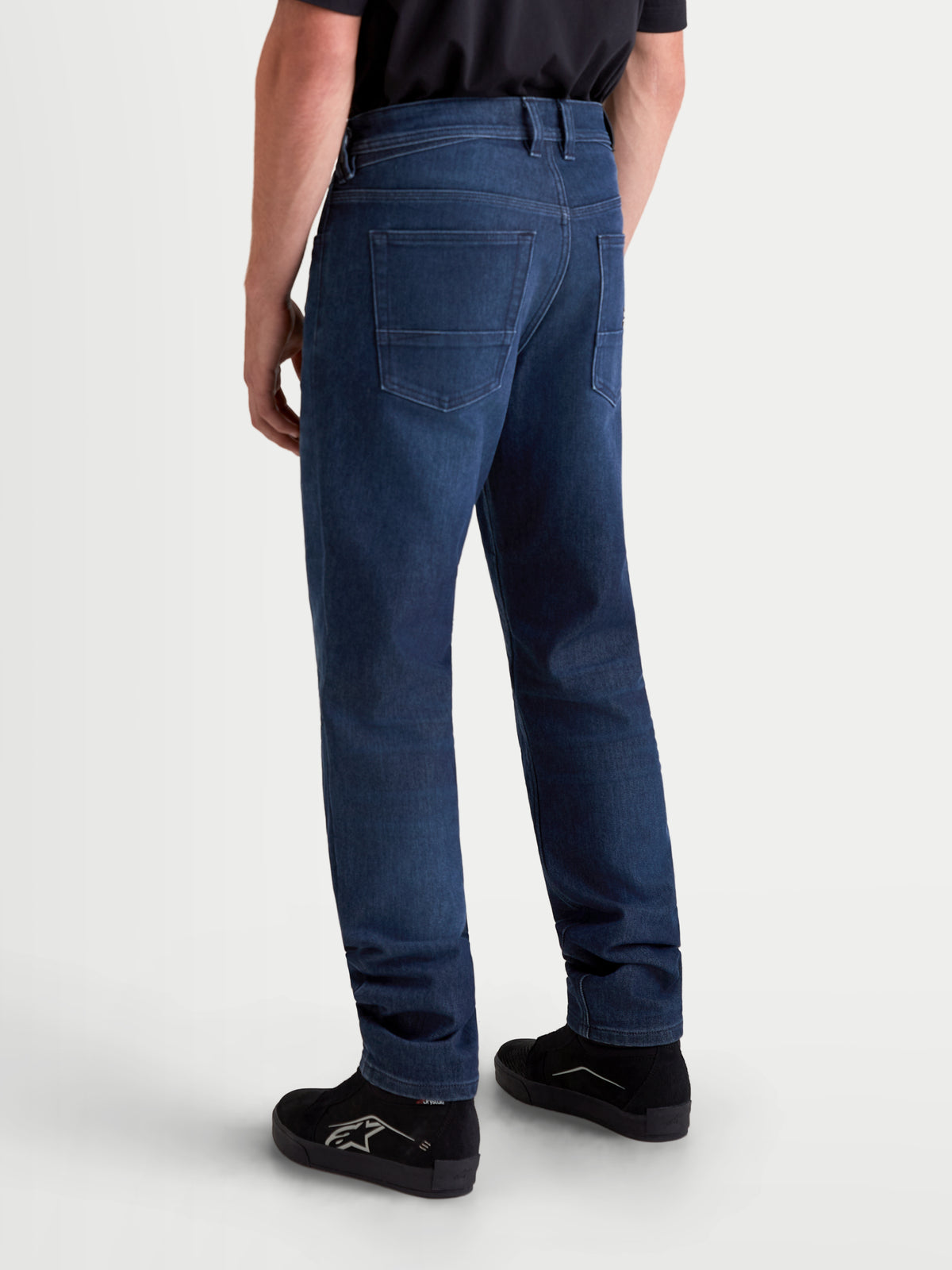 Alpinestars Flex-AST 10 Tough Max Denim Pants Short, men's urban motorcycle denim pants in dark blue, rear view showing single-layer technical denim construction, five-pocket layout, and regular tapered fit worn on a model