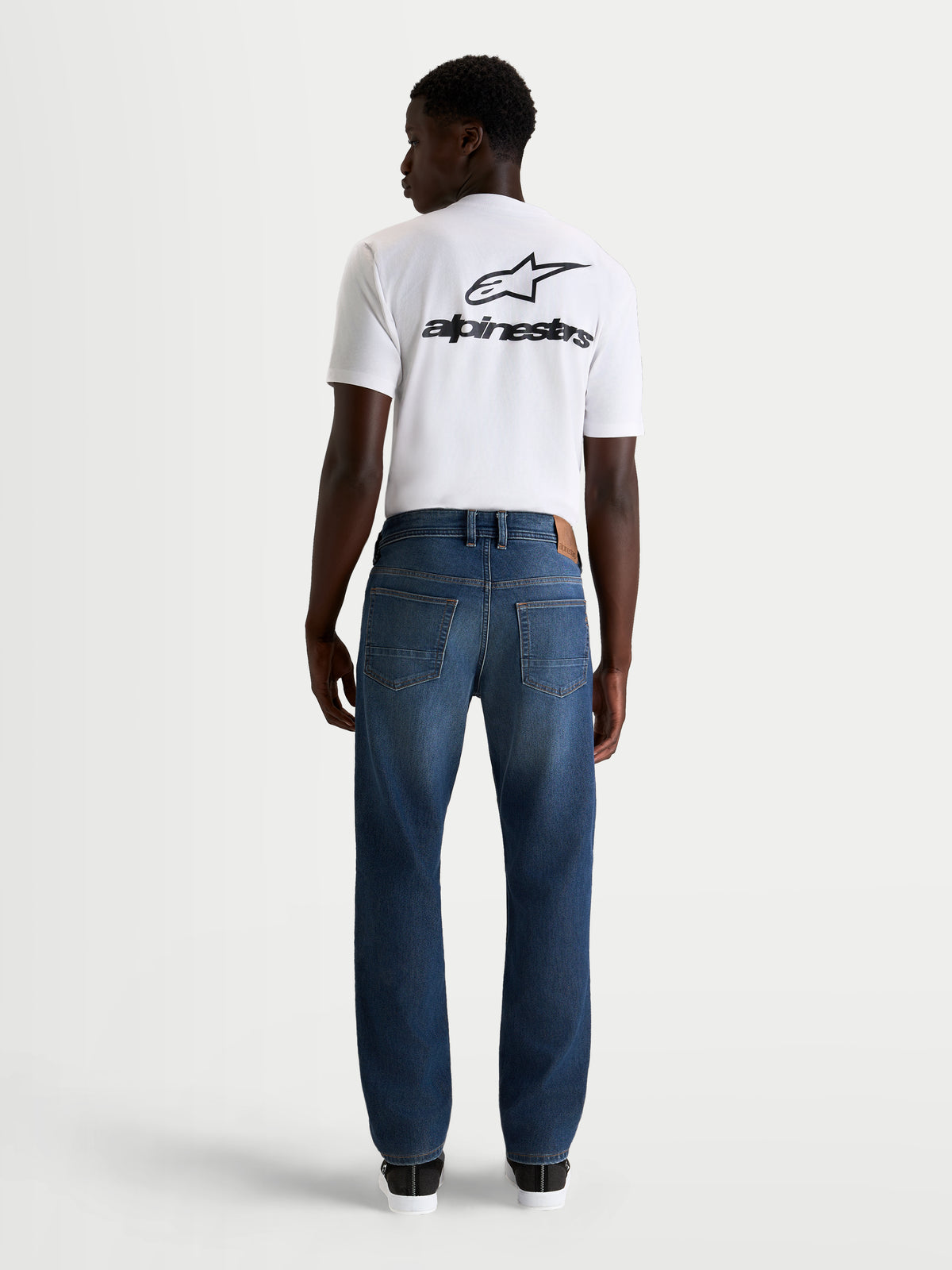 Alpinestars Flex Ast 8 Denim Spodnie motocyklowe męskie urban, niebieskie, widok z tyłu na jednowarstwową konstrukcję z denimu i klasyczny styl z pięcioma kieszeniami prezentowany przez modela