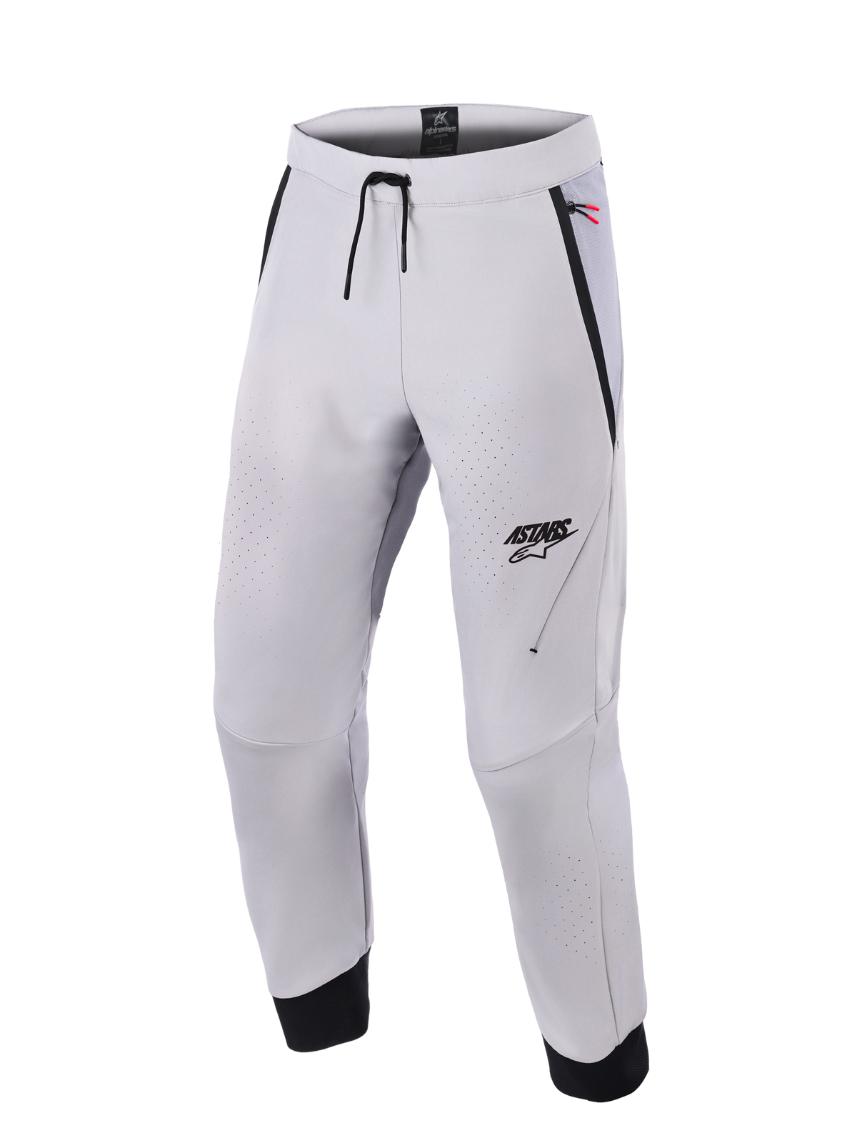 Alpinestars Aeroshell Airflow Pants, spodnie motocyklowe w kolorze Mid Gray, wyposażone w laserowo perforowane strefy wentylacyjne, logo ASTARS na lewym udzie, ściągacz w pasie i czarne mankiety na kostkach, techniczna konstrukcja softshell do jazdy sportowej i miejskiej
