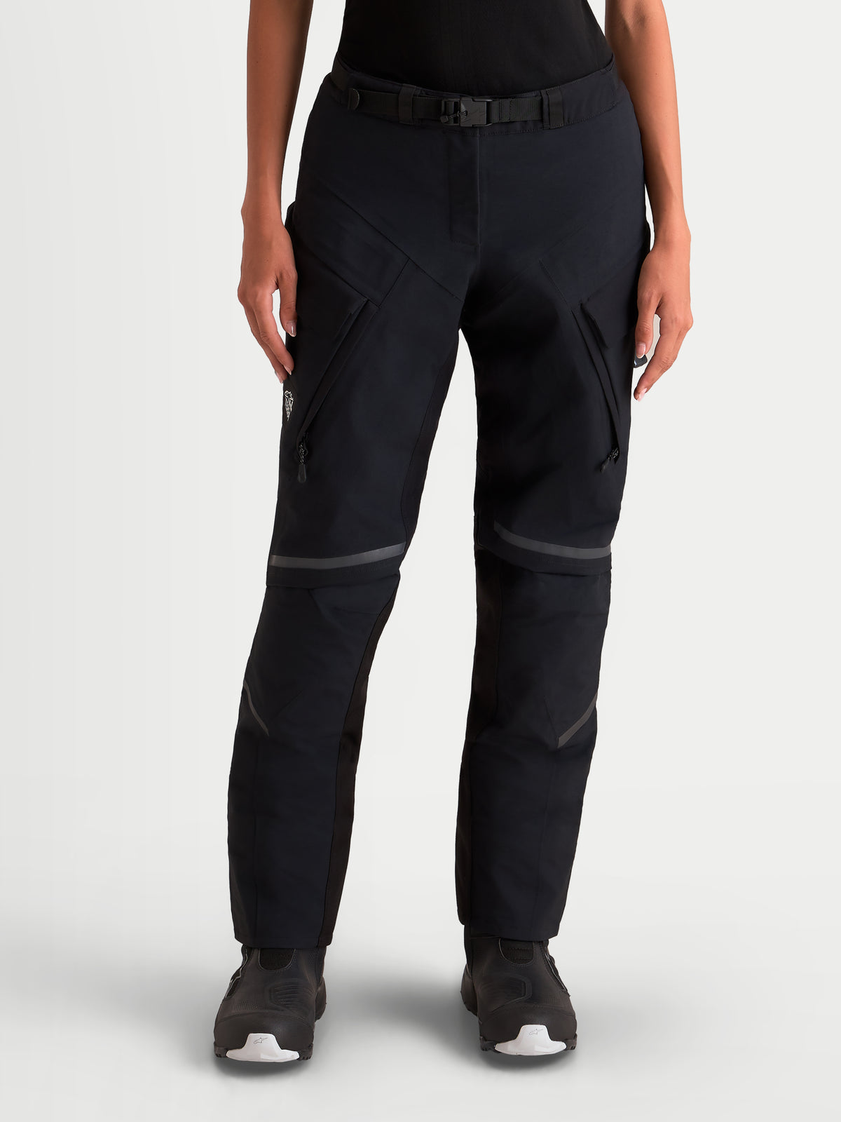 Alpinestars Stella St-7 V2 2L Gore-Tex Pants, women's adventure touring motorcycle pants in black, front view on a model wearing waterproof textile gear with cargo pockets and integrated belt.