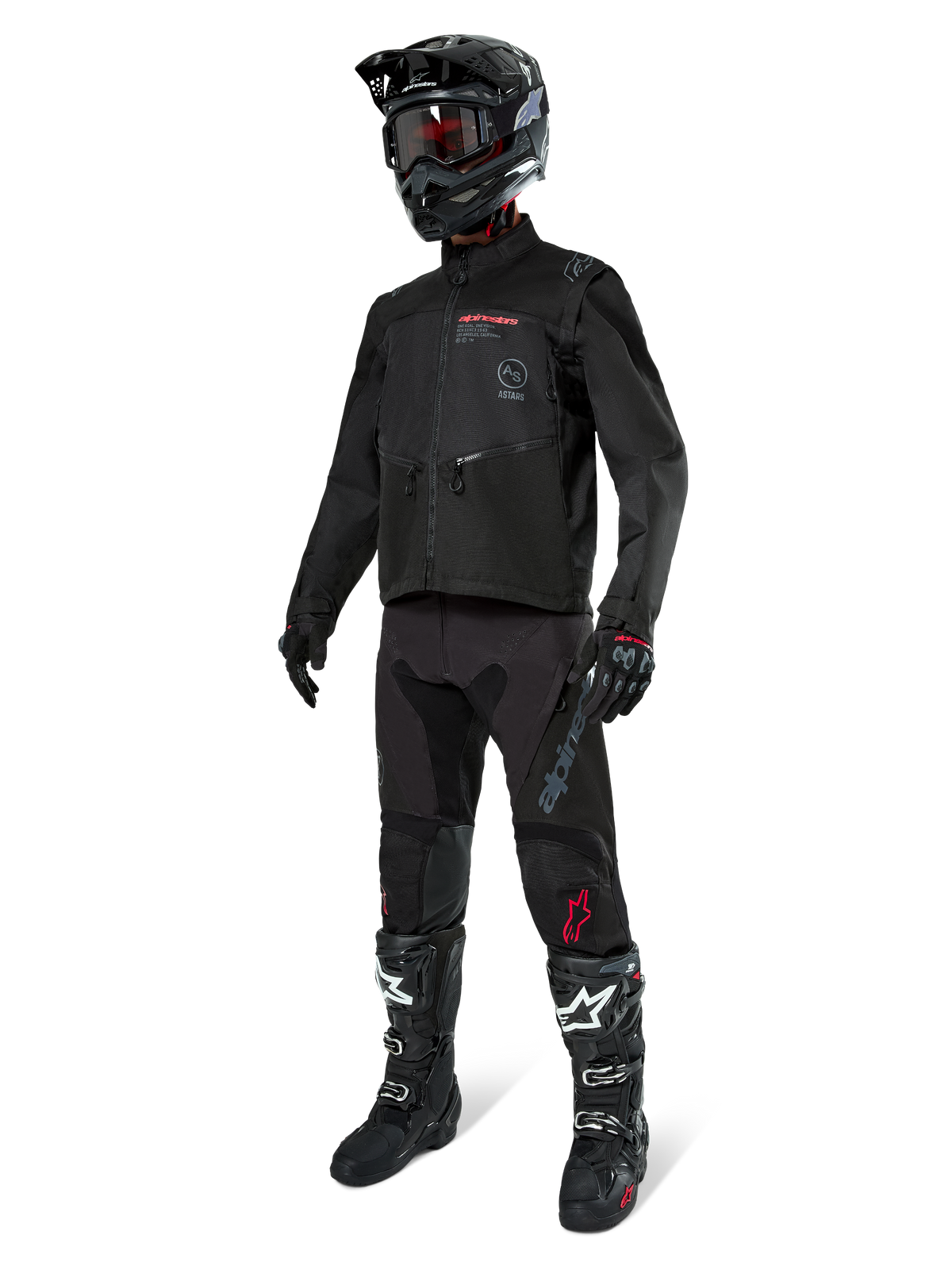 Motocyklista motocrossowy w pełnym stroju wyścigowym, kurtka Alpinestars Pro-Dura w kolorze czarnym, czarne spodnie z szarym brandingiem i czerwonymi akcentami, czarny kask z goglami oraz czarno-białe buty motocrossowe, dopasowany ubiór do jazdy enduro i off-road