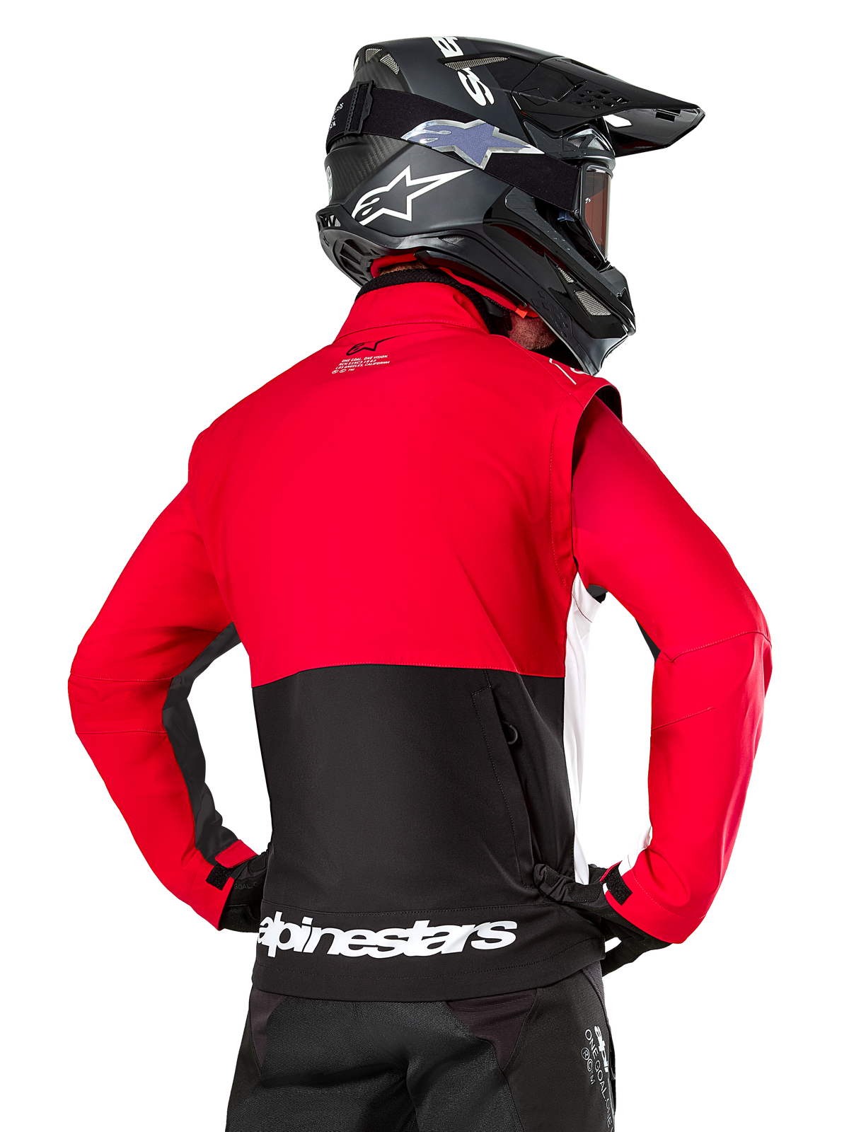 Alpinestars Pro-Dura Jacket, Off-Road Enduro Jacket, Red and Black with white Alpinestars logo on back hem, worn by rider from behind with a black motocross helmet, rally-inspired design for aggressive trail riding