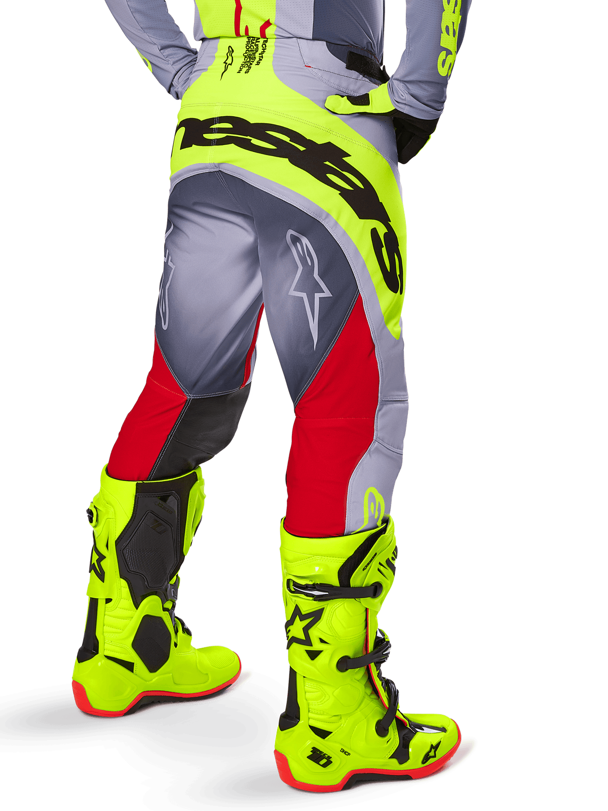 Alpinestars 2025 Techstar Melt Pants, Motocross Pants, Bright Red and Gray with neon yellow accents, rear view highlighting large black branding on the seat, worn with matching bright yellow boots and a gray jersey, athletic race fit for off-road competition.