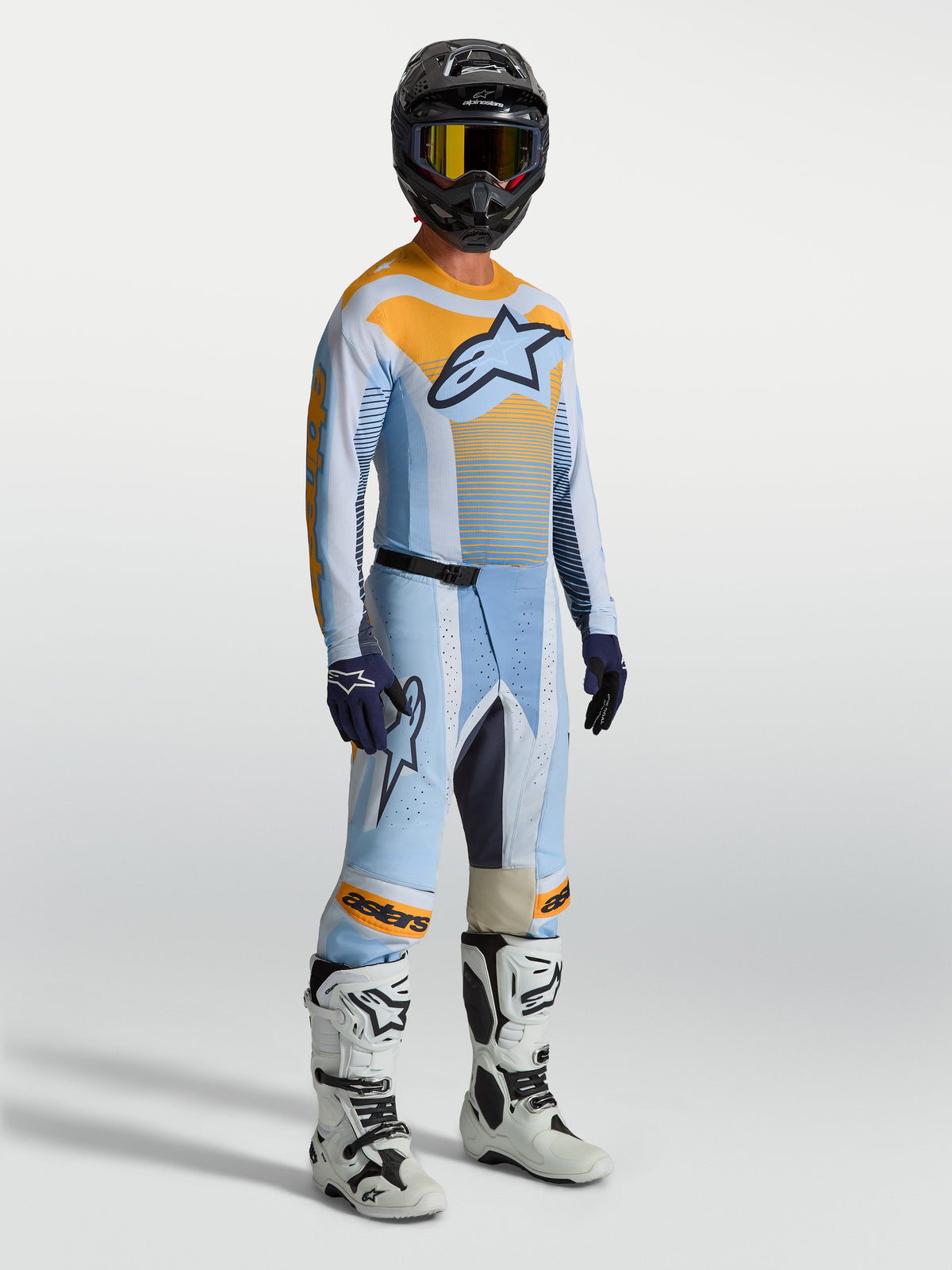 Spodnie Alpinestars Techstar Maven, męskie spodnie motocrossowe, niebieskie i pomarańczowe, sportowy krój wyścigowy z elastycznymi strefami do jazdy off-road.