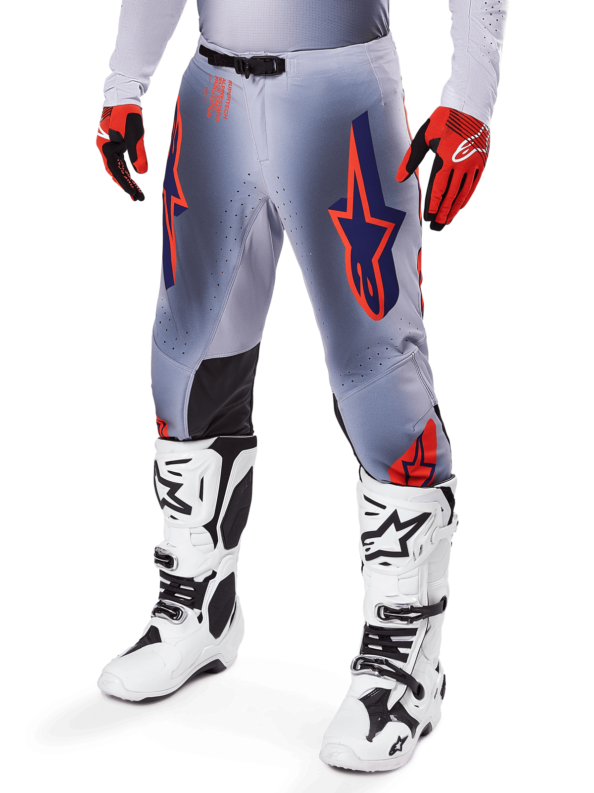 Alpinestars 2025 Supertech Lipan Pants, Motocross Pants, Gray and Orange Fluo, featuring navy star designs and black inner knee panels, worn with red-orange gloves and white boots, professional off-road racing gear
