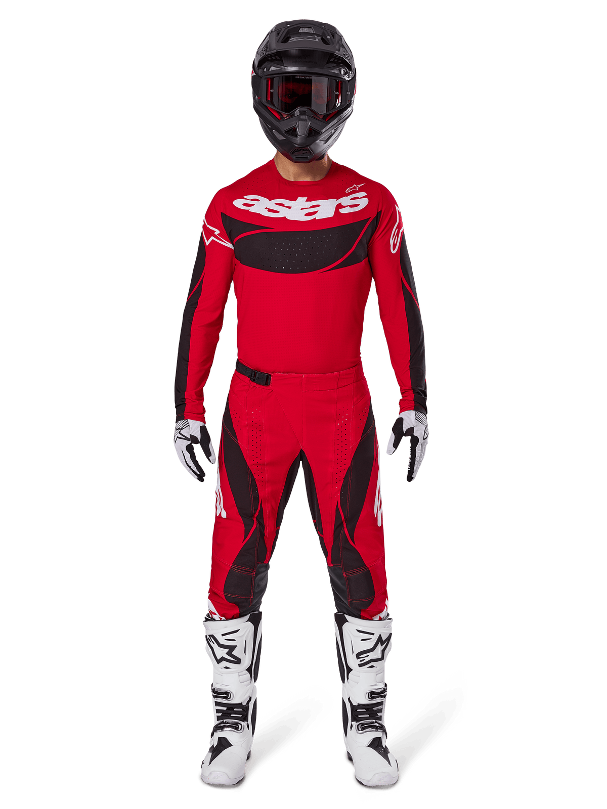 Alpinestars 2025 Techstar Dreem Pants, spodnie motocrossowe, jaskrawoczerwone i czarne, noszone jako część kompletnego zestawu wyścigowego z pasującą czerwoną koszulką, czarnym kaskiem i białymi butami, sportowy design z wyrazistym logo do jazdy terenowej.