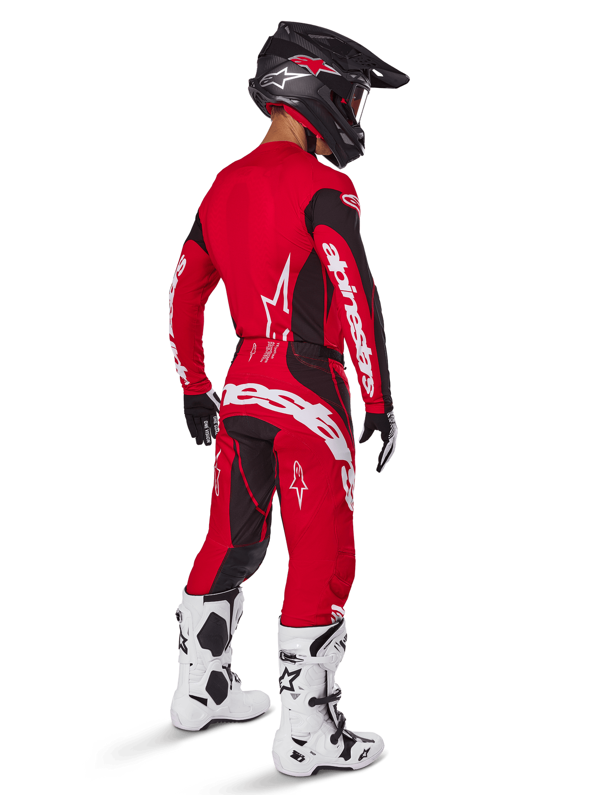 Alpinestars 2025 Techstar Dreem Pants, spodnie motocrossowe, jaskrawoczerwone i czarne, widziane z tyłu na motocykliście w pełnym stroju wyścigowym z dopasowaną czerwoną koszulką, czarnym kaskiem i białymi butami, wyraźne białe logo Alpinestars i czarne elastyczne panele.