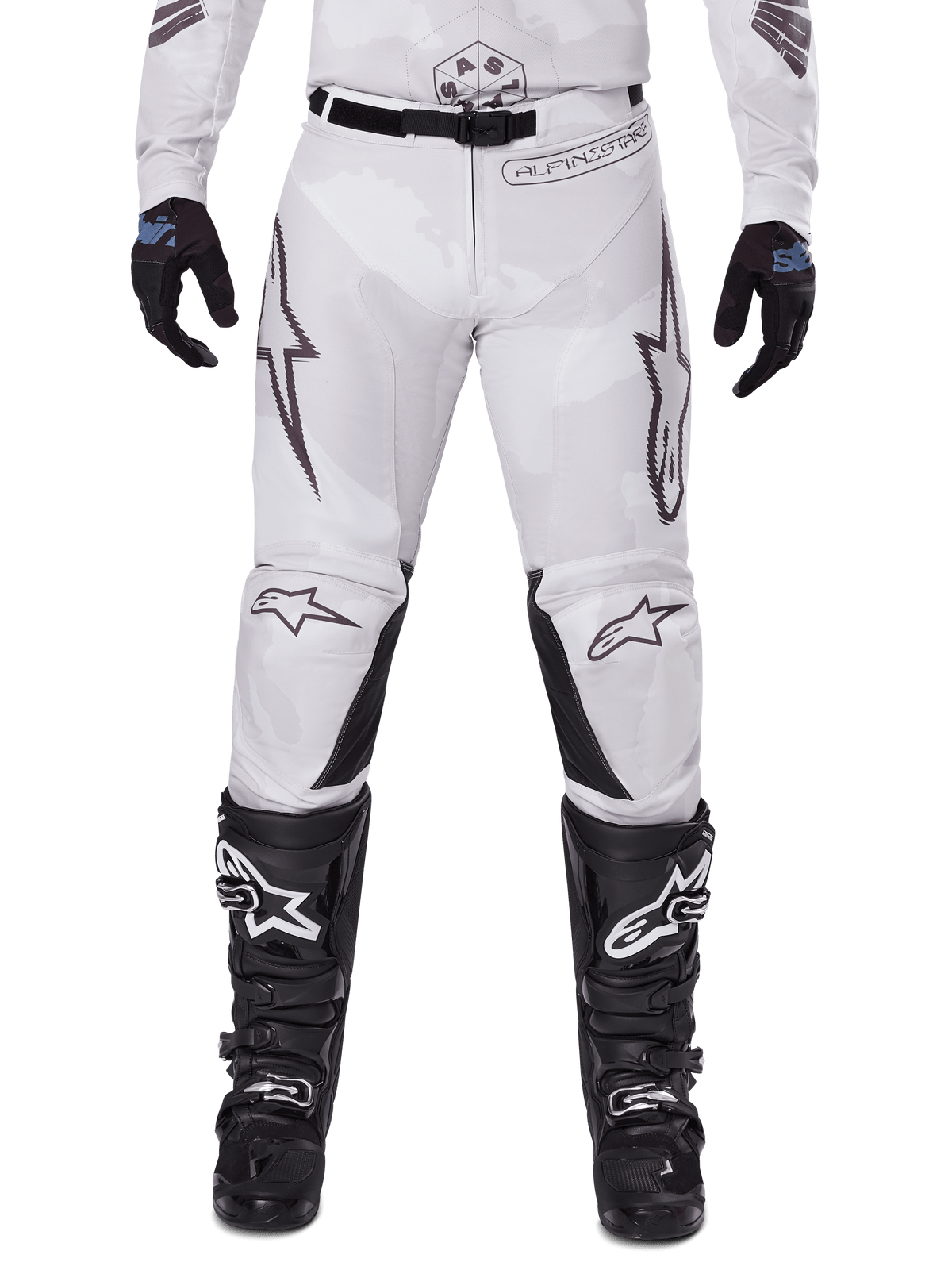 Alpinestars 2025 Racer Hollow Pants, Motocross Pants, Light Camo Brown, worn with black gloves and motocross boots, featuring a subtle camo pattern with black graphic prints and Astars logos, ergonomic design for performance off-road riding