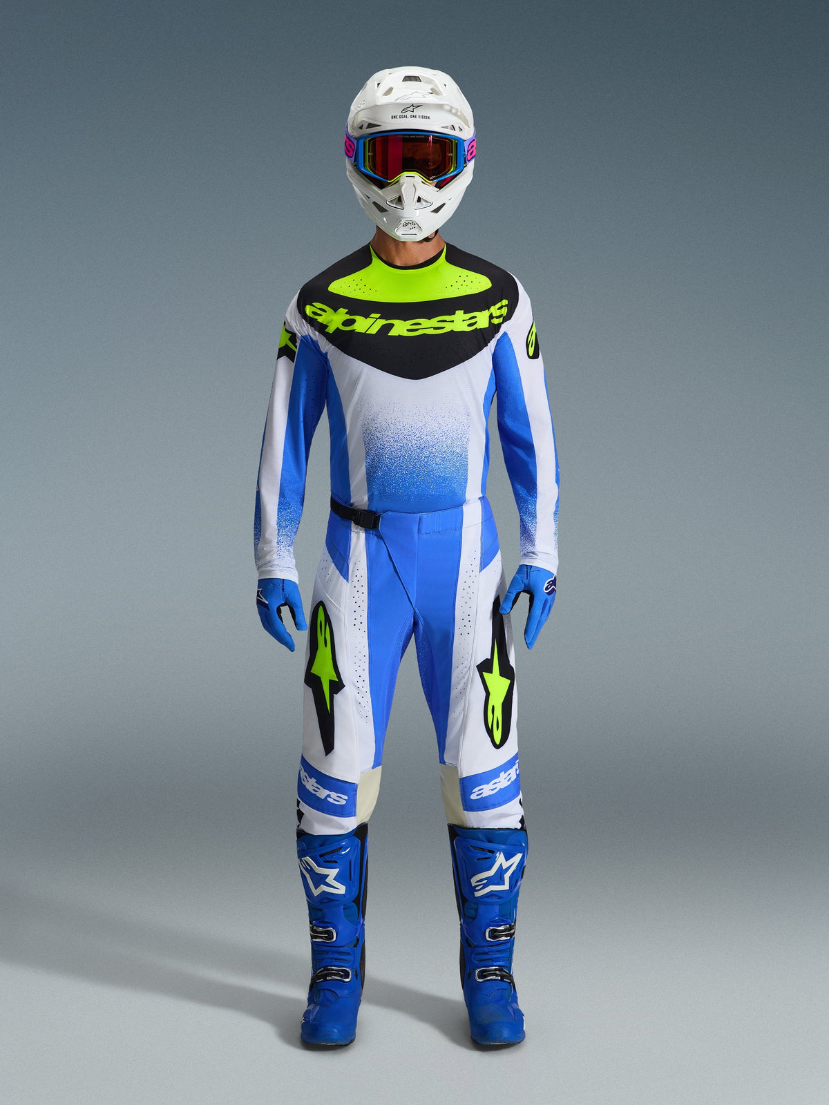 Alpinestars 2026 Techstar Knif Pants, Motocross Pants, Ucla Blue, Black, and Yellow Fluo, part of a full racing gear set with matching jersey, blue boots, blue gloves, and white helmet, athletic race fit with bold Alpinestars branding.