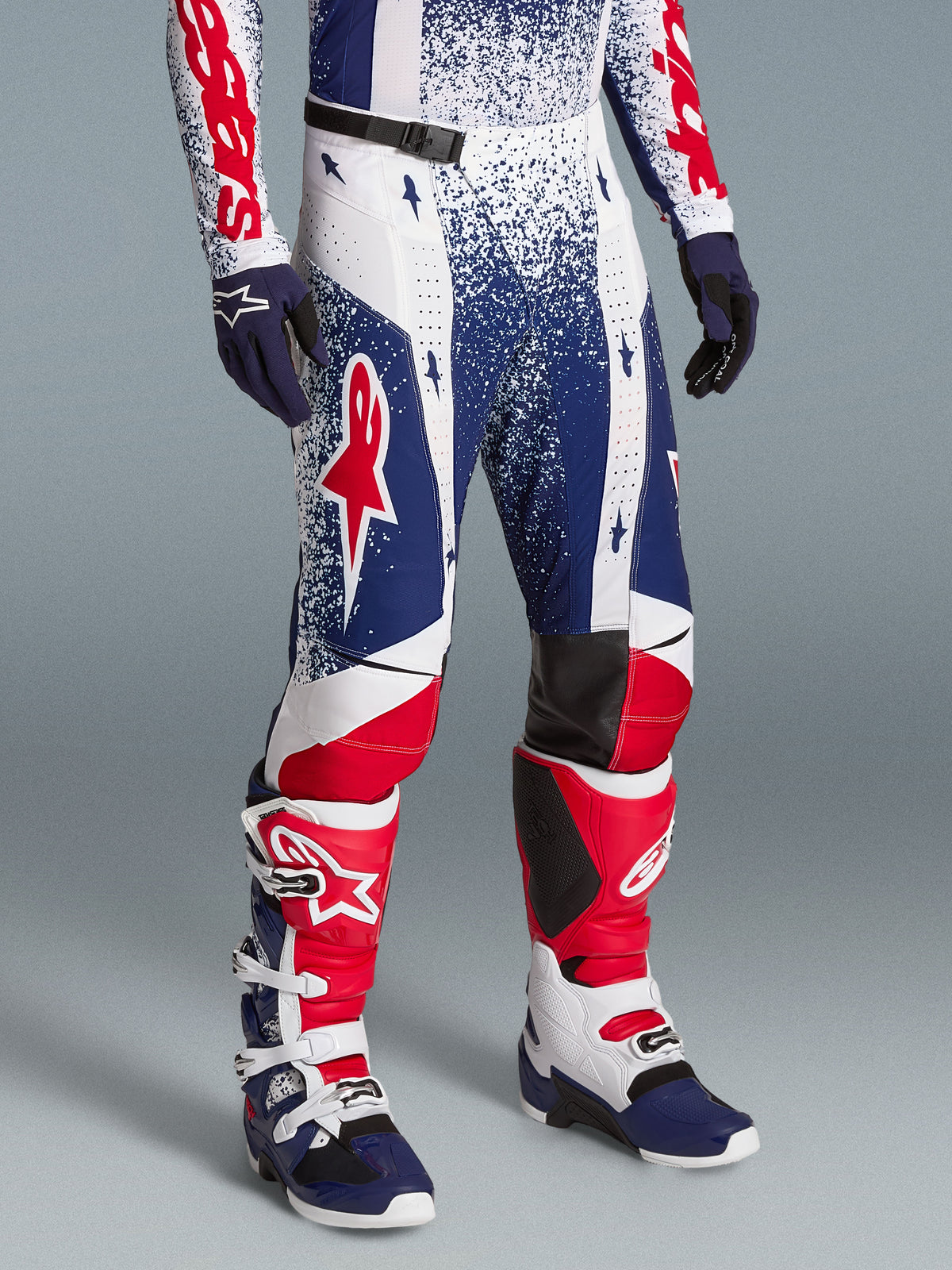 Alpinestars Techstar Unity, męskie spodnie motocrossowe, białe, niebieskie i czerwone, limitowana edycja, krój wyścigowy.