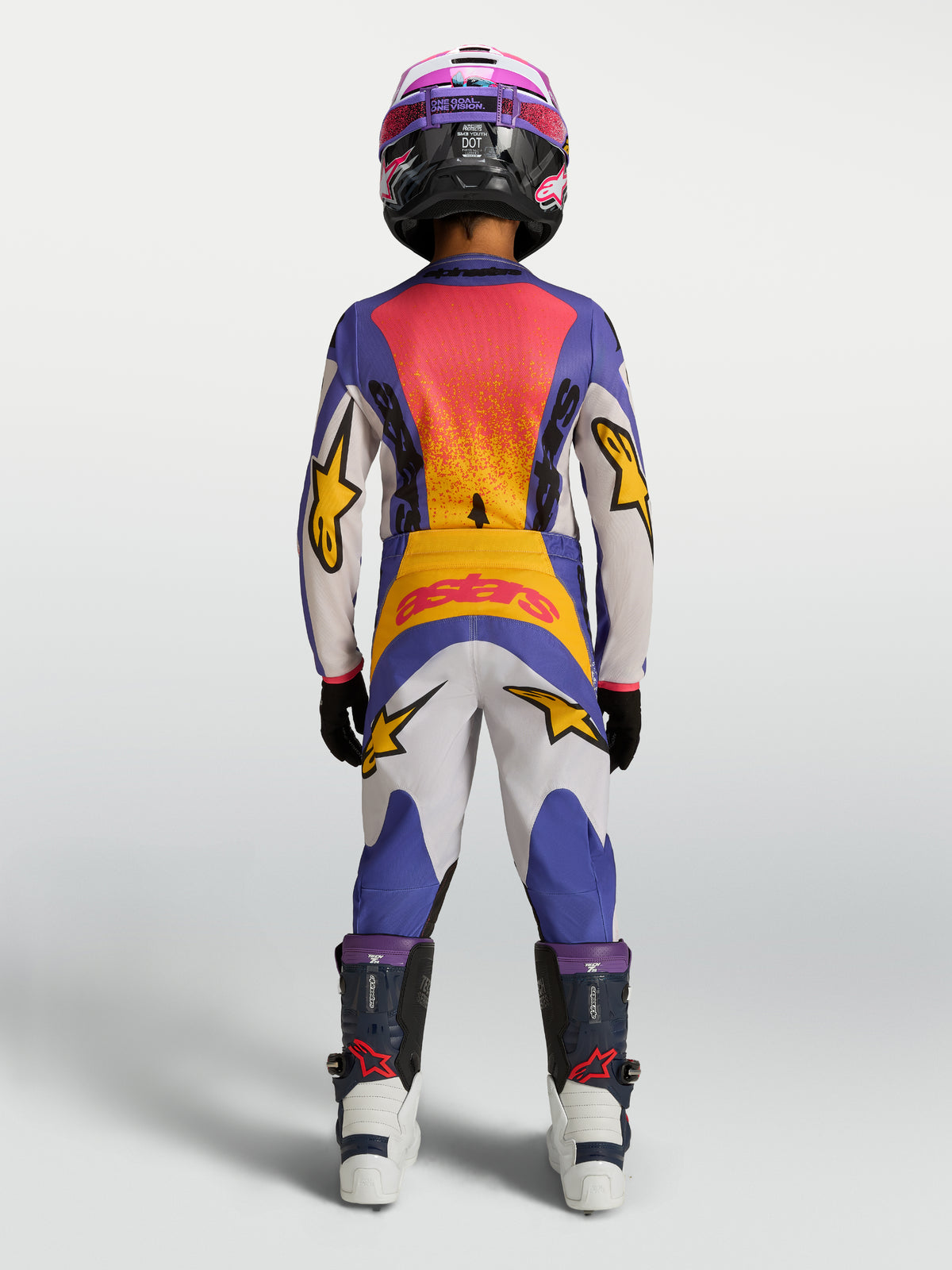 Alpinestars Spodnie Fluid Drag Młodzieżowe, niebieskie i białe spodnie motocrossowe z żółtymi akcentami, widok z tyłu na modelu.